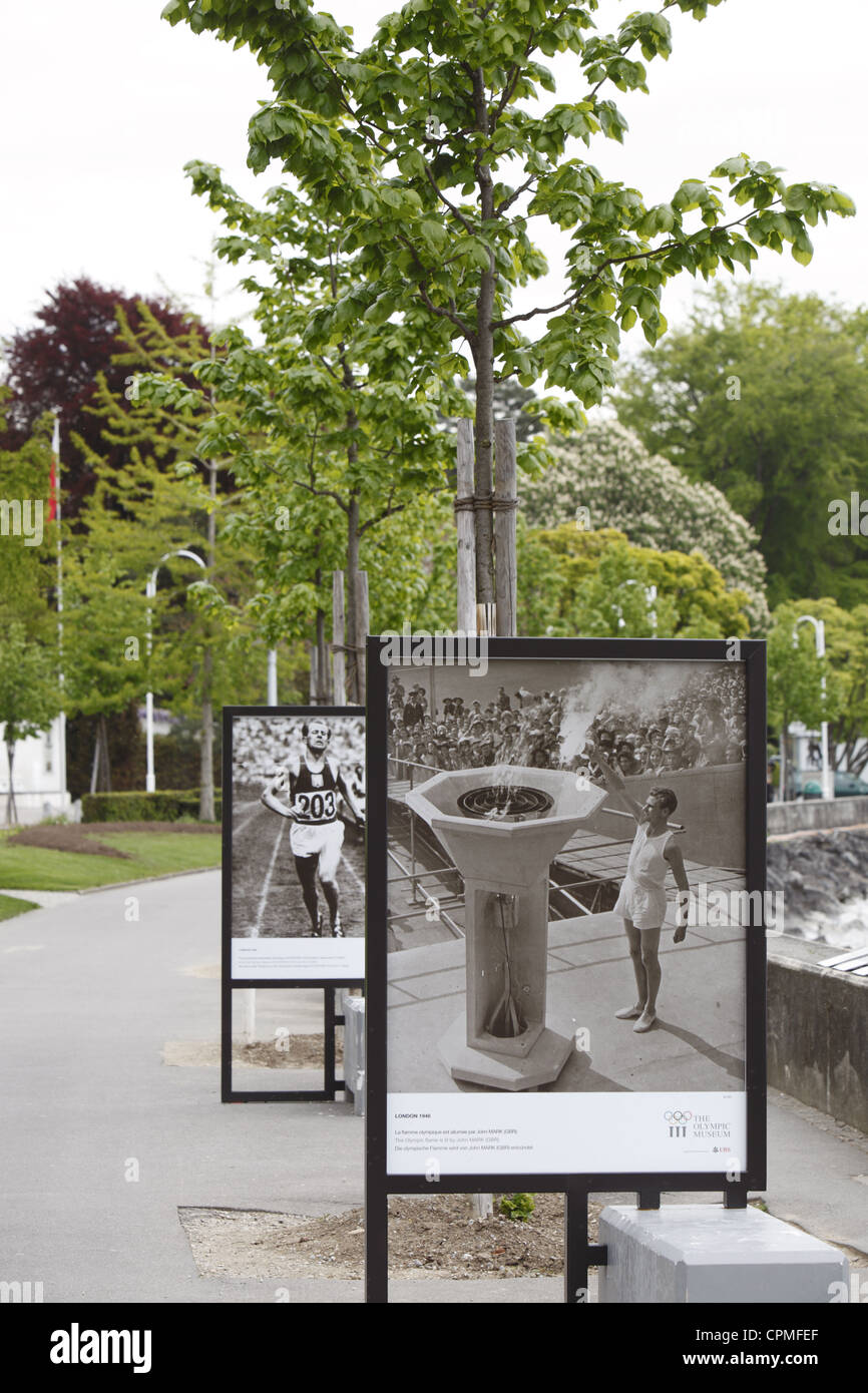 IOC Olympic posters on the edge of Lake Geneva leading to the Chateau de Ouchy in Lausanne, Vaud, Switzerland Stock Photo