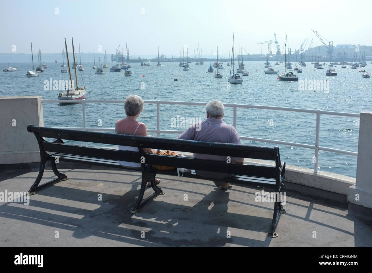A couple look out in the bay at Falmouth, UK Stock Photo