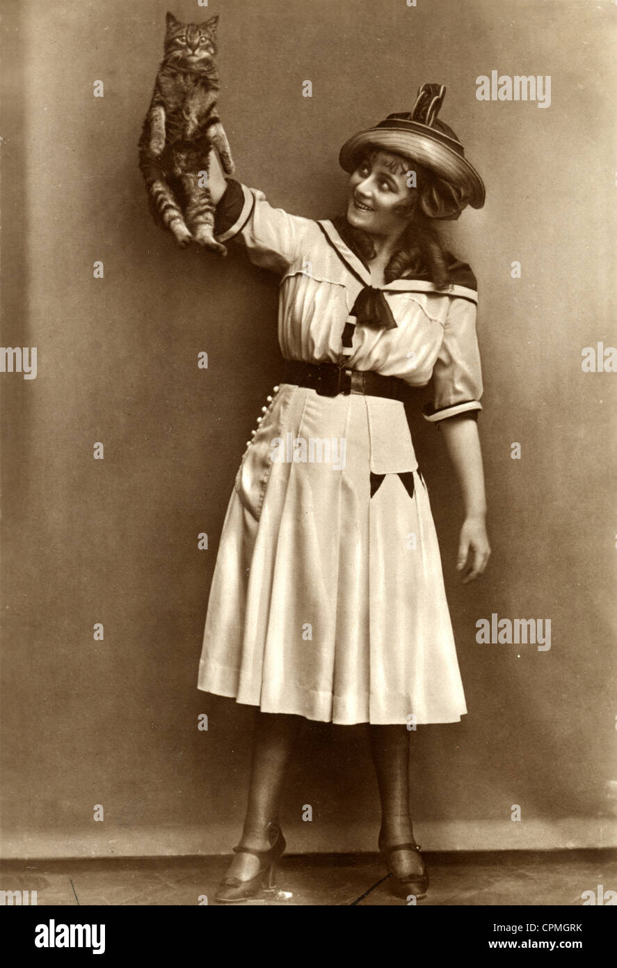 Amused Woman Holding Stunned Cat Aloft Stock Photo
