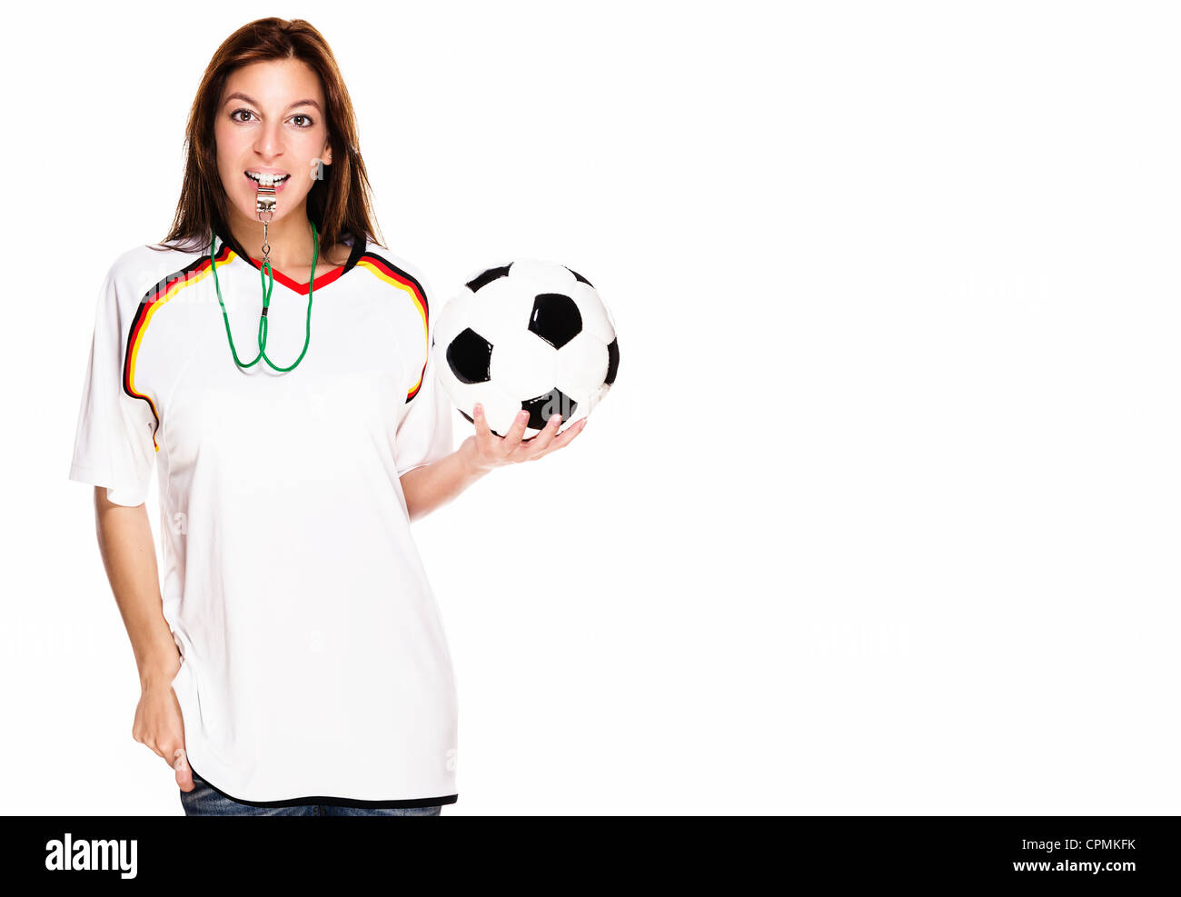 beautiful woman with a whistle wearing football shirt and holding football on white background Stock Photo