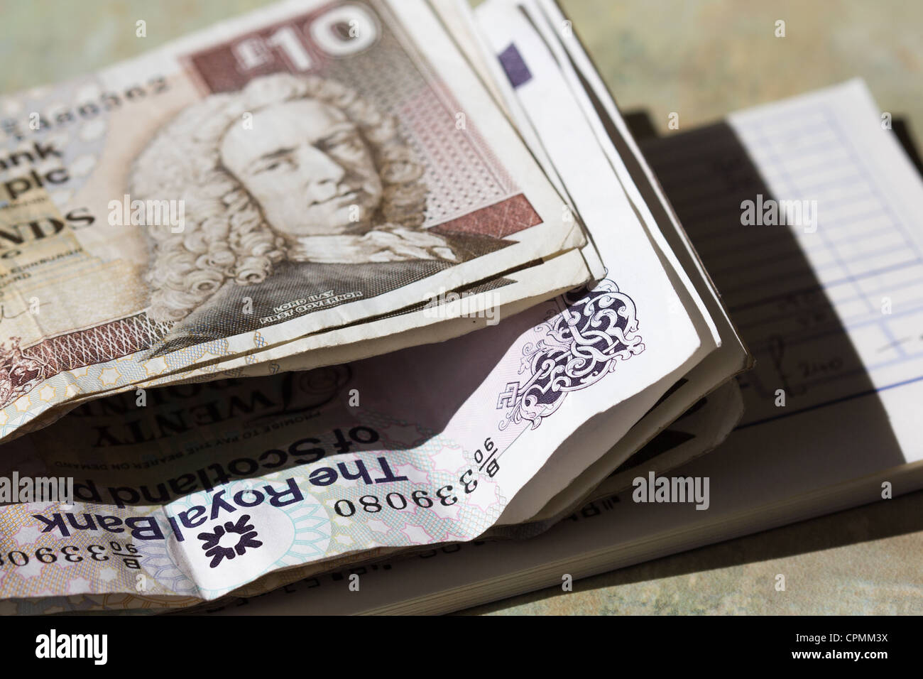 Scottish bank notes with Bank pay in book for small business.. UK Stock Photo