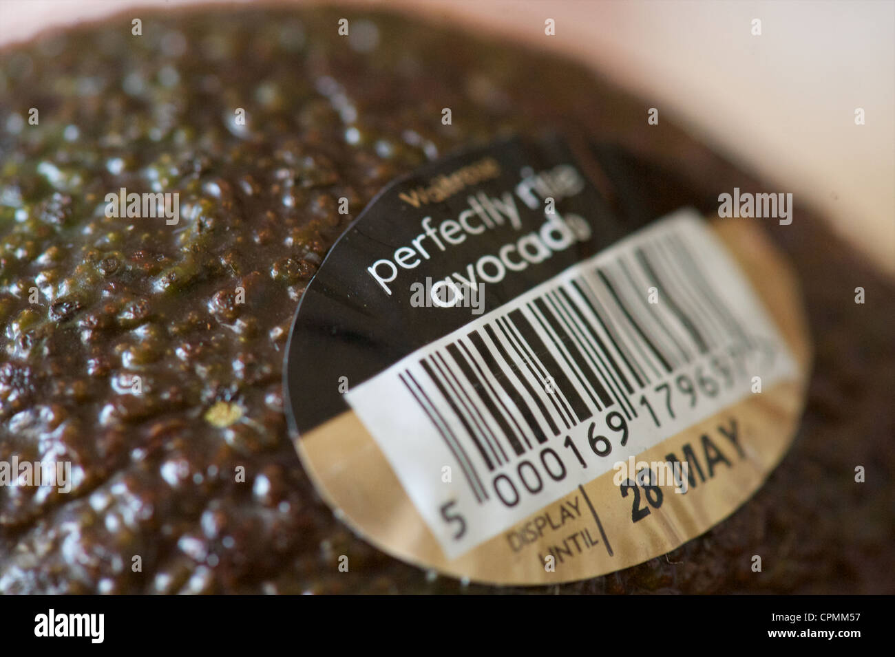 detail of a Waitrose labeled Perfectly Ripe Avocado Stock Photo