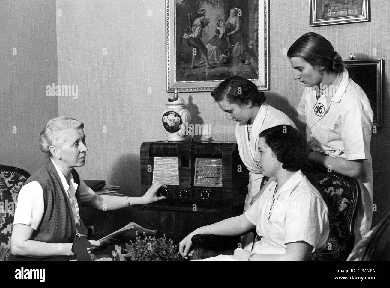 Young people and an old woman listen to the radio, 1934 Stock Photo - Alamy