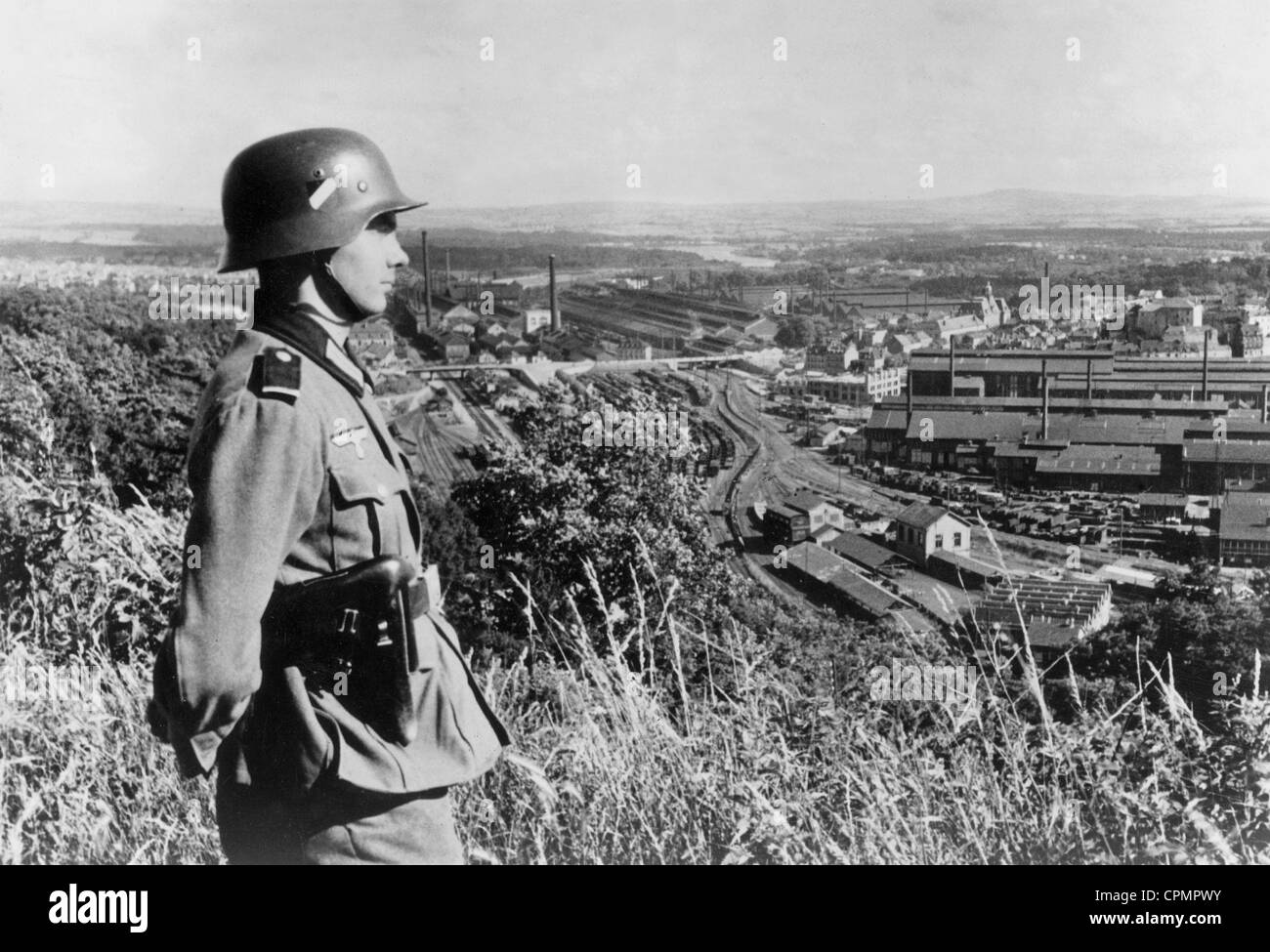 A German soldier looks at the Schneider plants in Le Creusot, 1940 Stock Photo