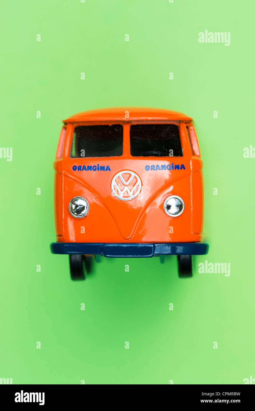 Orange Matchbox Die cast Volkswagen van on green background Stock Photo