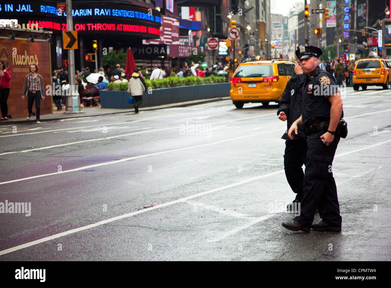 NYPD police officers in Times Square, New York city, Manhattan patrolling the streets looking