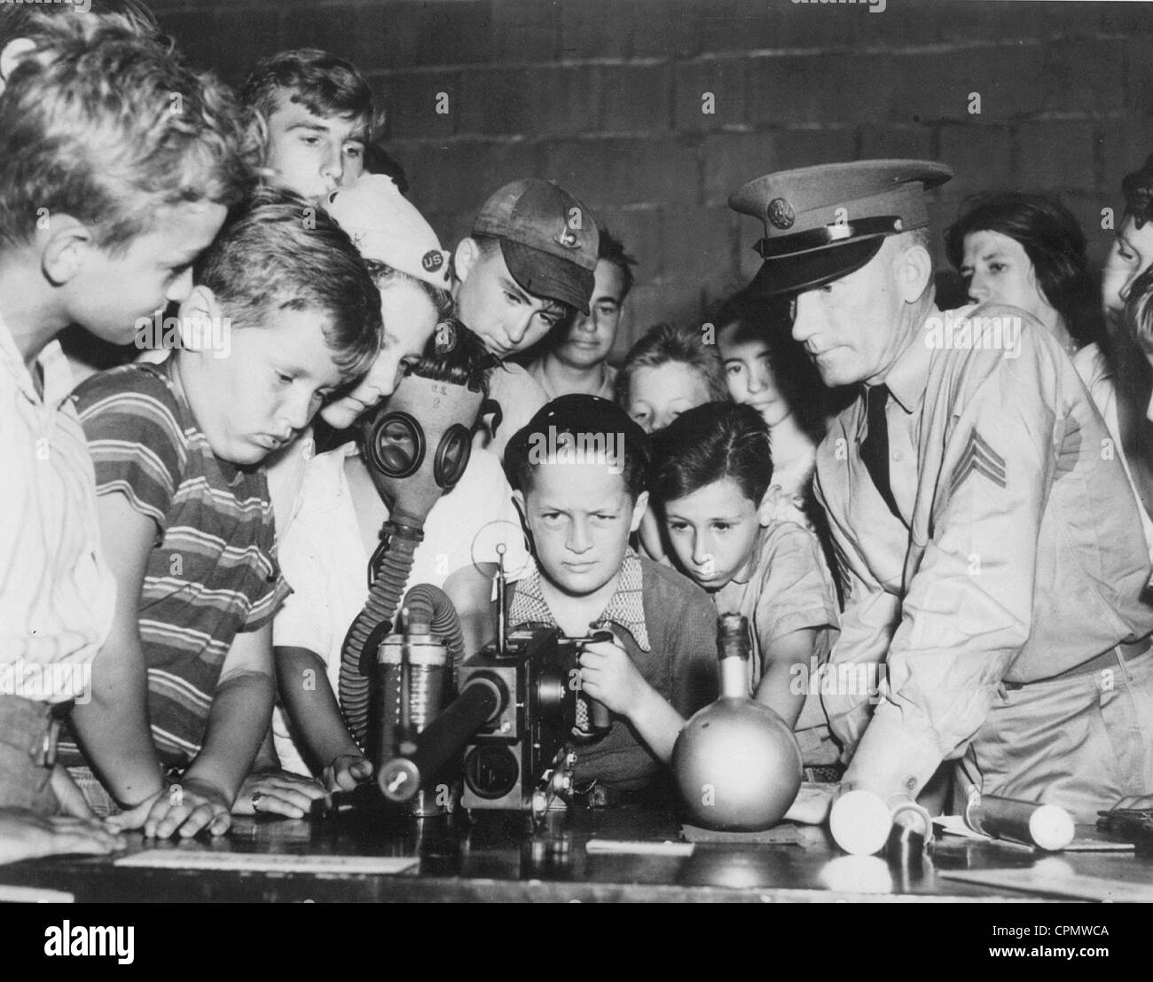 American soldier with children and teens at a presentation, 1939 Stock Photo