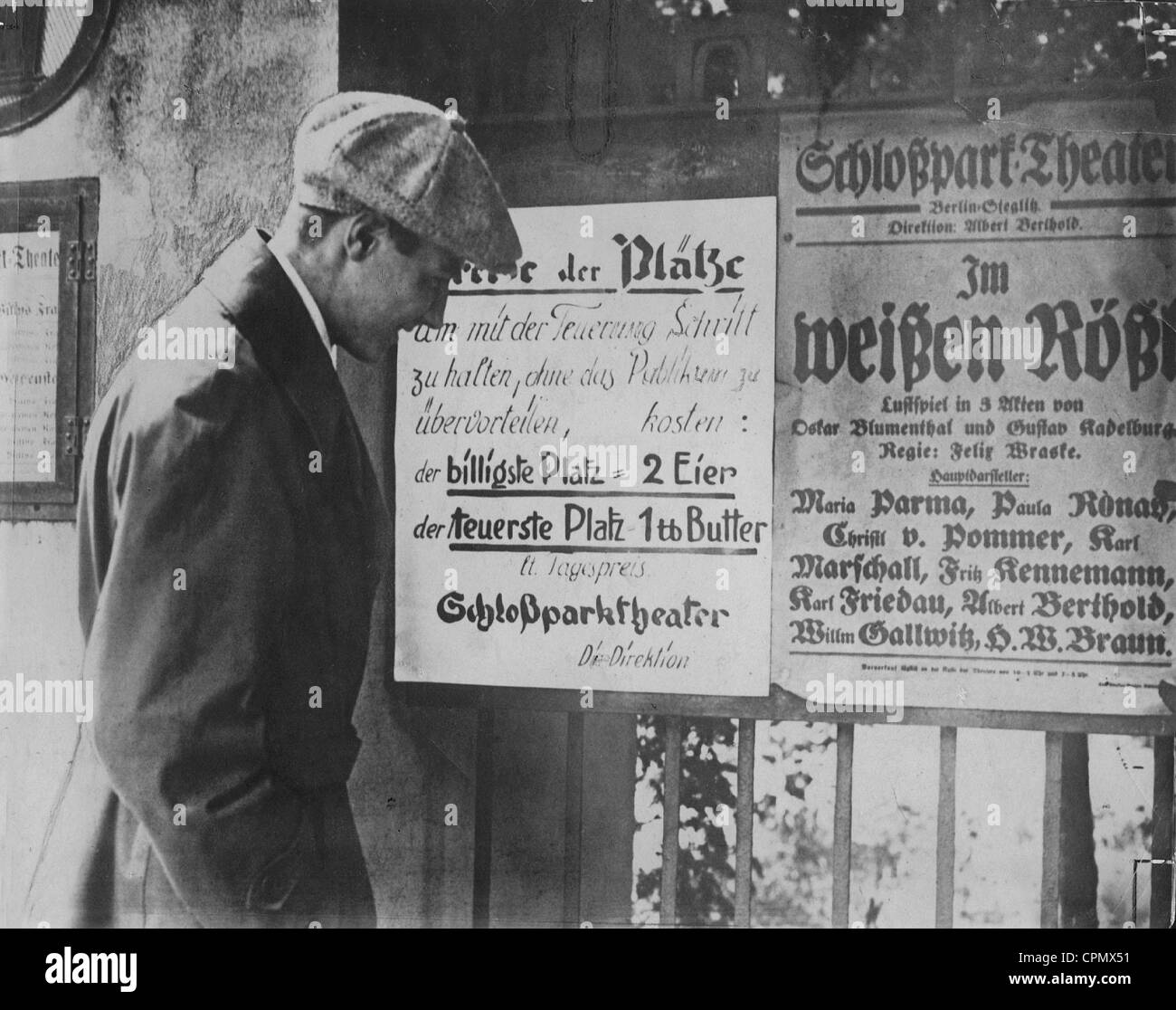 A Man standing in front of Berlin's Schlossparktheater reading about ticket prices, Berlin Steglitz, 1923 (b/w photo) Stock Photo