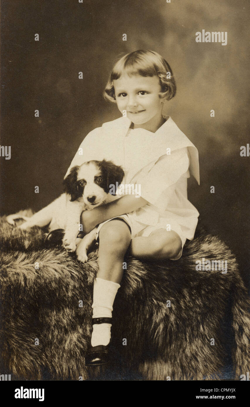 Happy Little Girl Cradling her Puppy Stock Photo