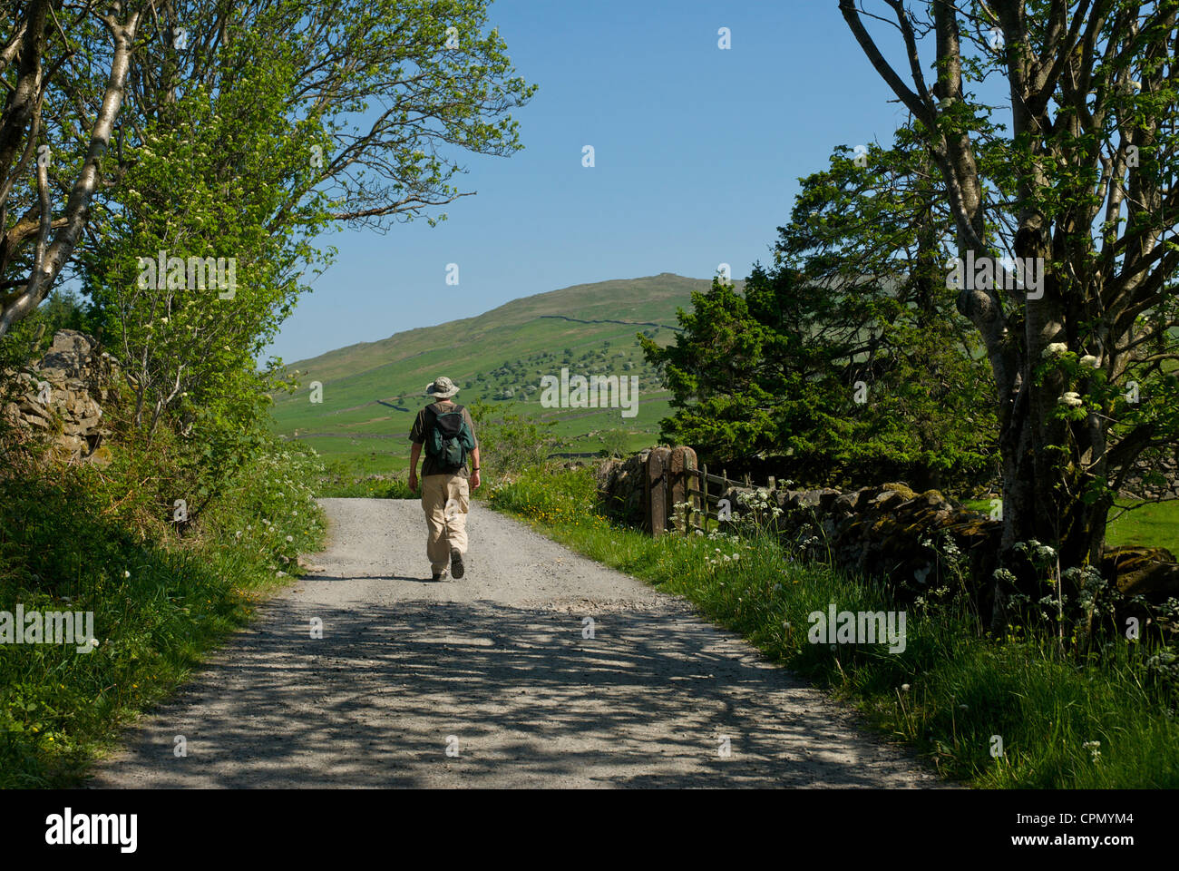 Man walking along old track, Dubbs Road, in the Troutbeck Valley, Lake District National Park, Cumbria, England UK Stock Photo