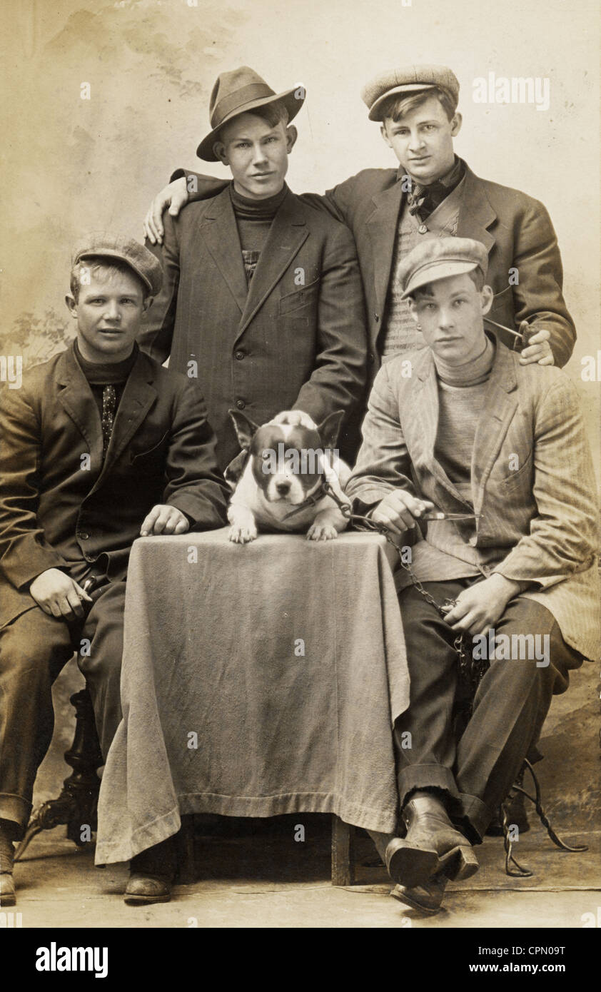 Four Young Tough Guys Surrounding Small Dog Stock Photo