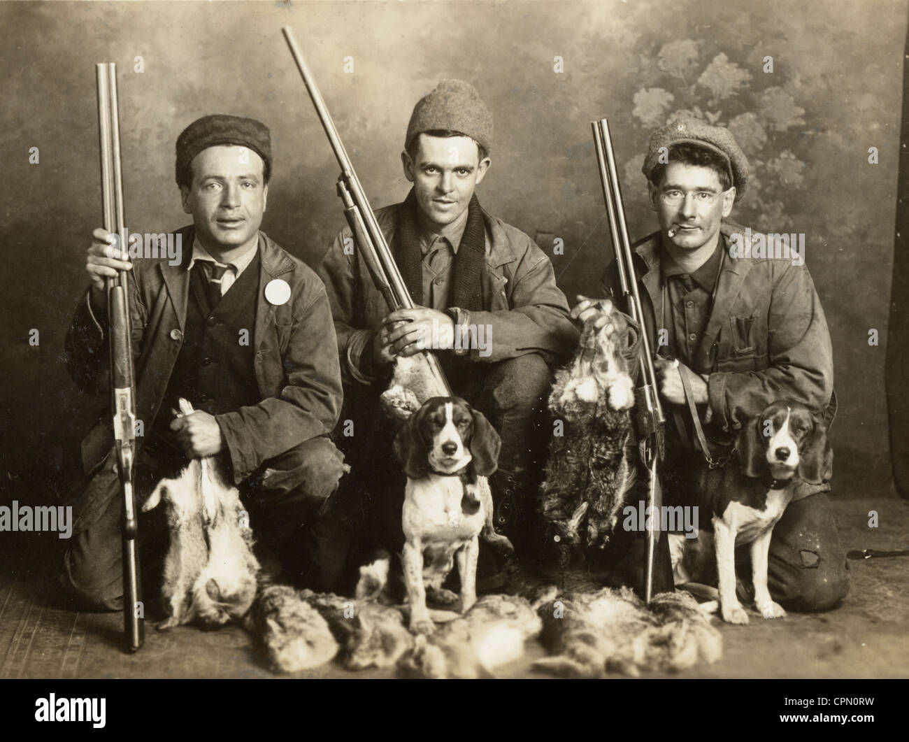 Three Rabbit Hunters & Beagles with Dead Game Stock Photo - Alamy