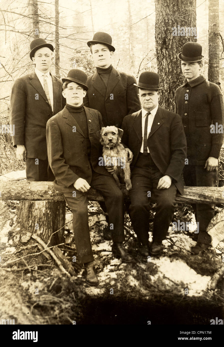Five Tough Guys Outdoors with Scared Terrier Dog Stock Photo