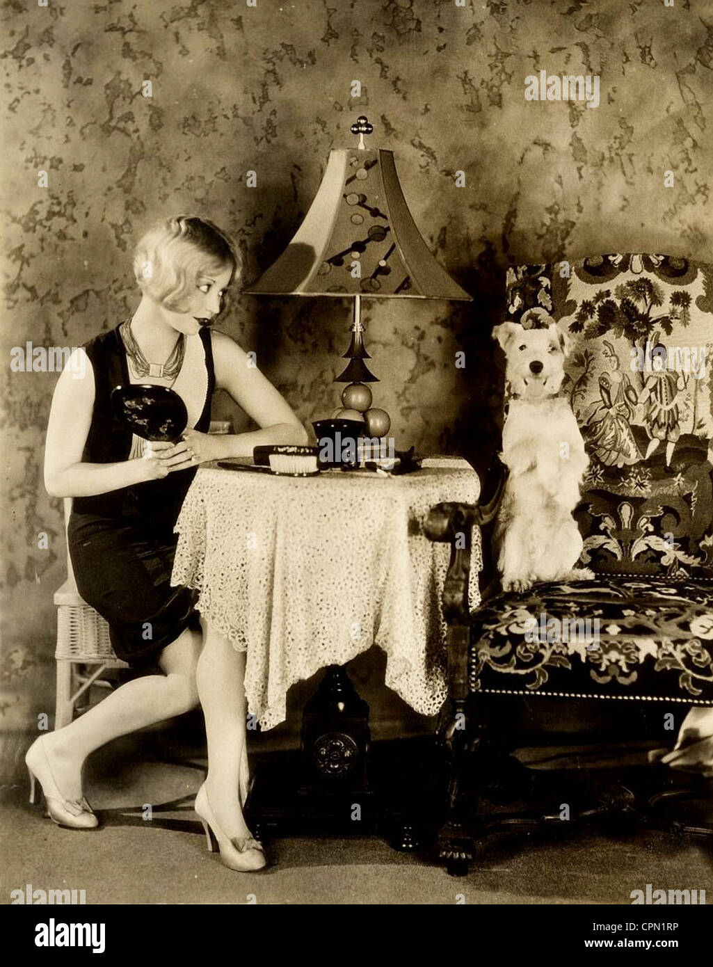 Flapper Making Googly Eyes at her Pet Dog Stock Photo