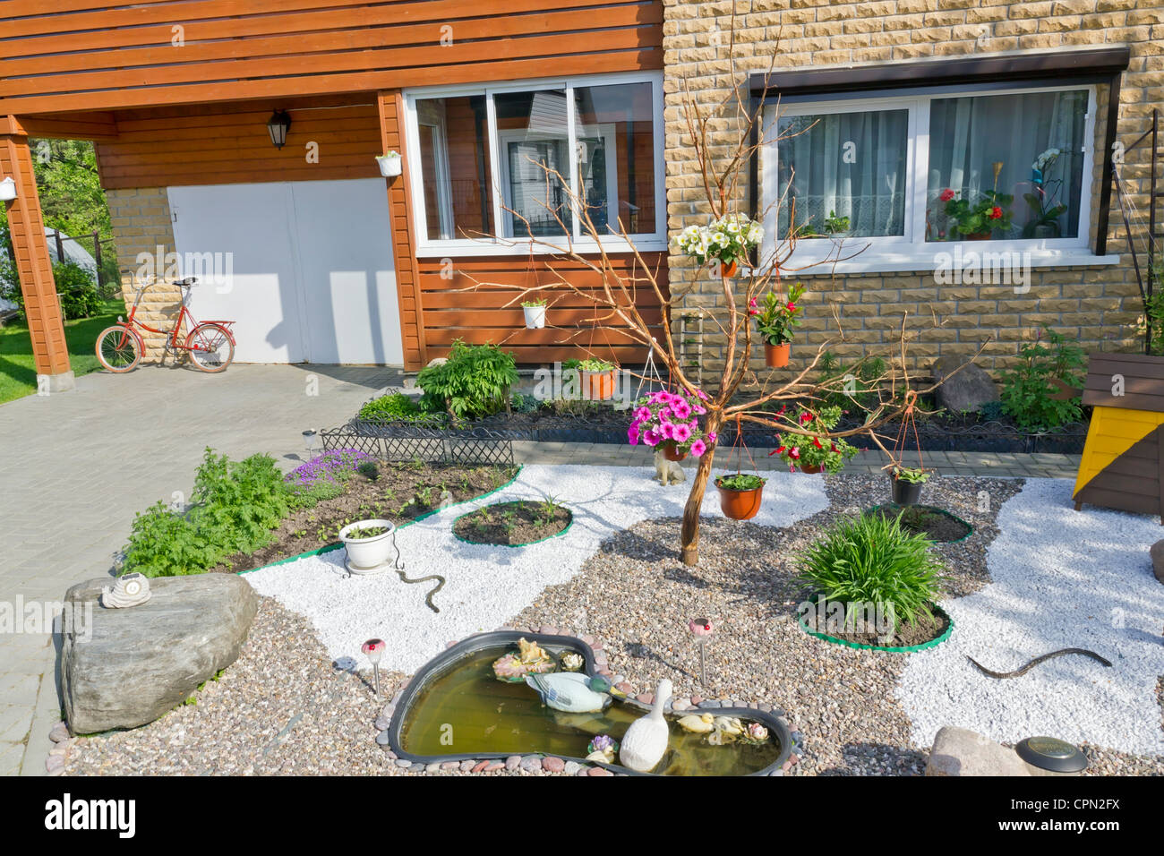 A quiet village courtyard near the house. Flowers, gravel paths