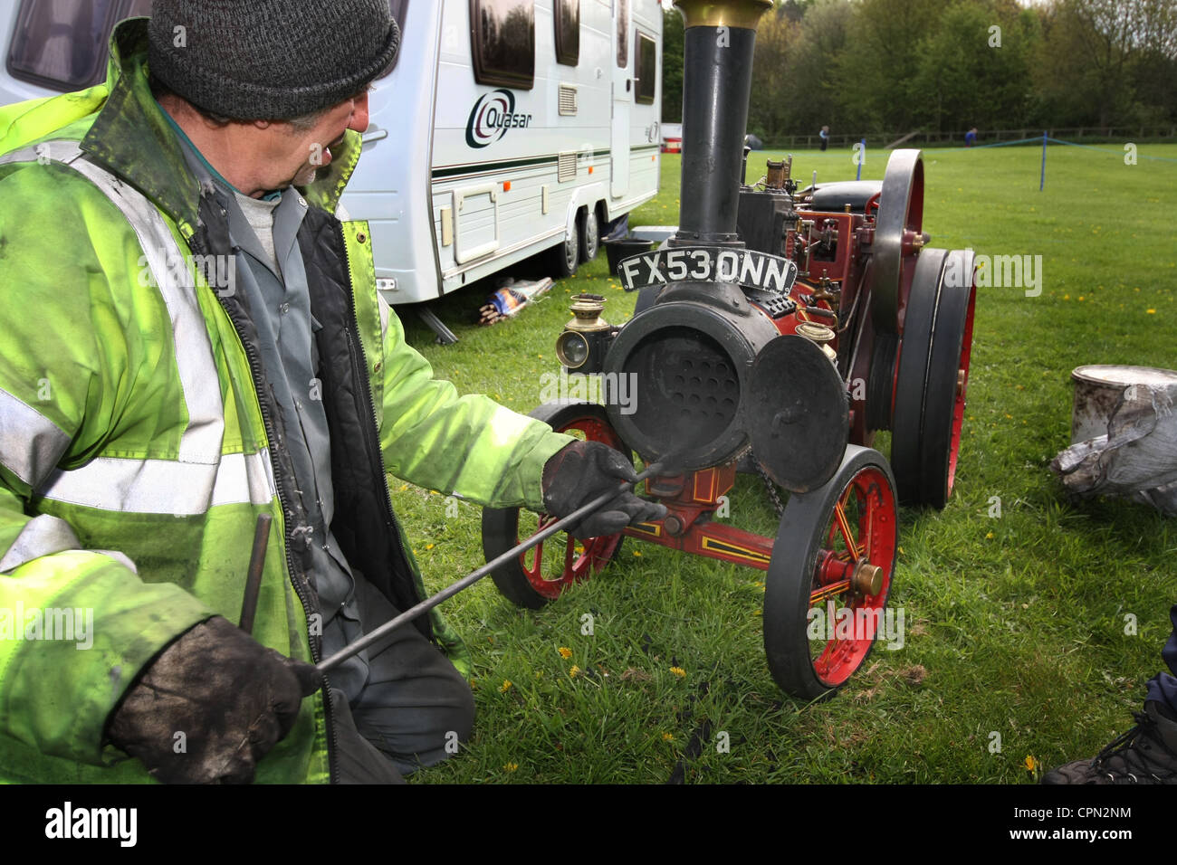 Man cleaning boiler of steam powered traction engine Stock Photo - Alamy