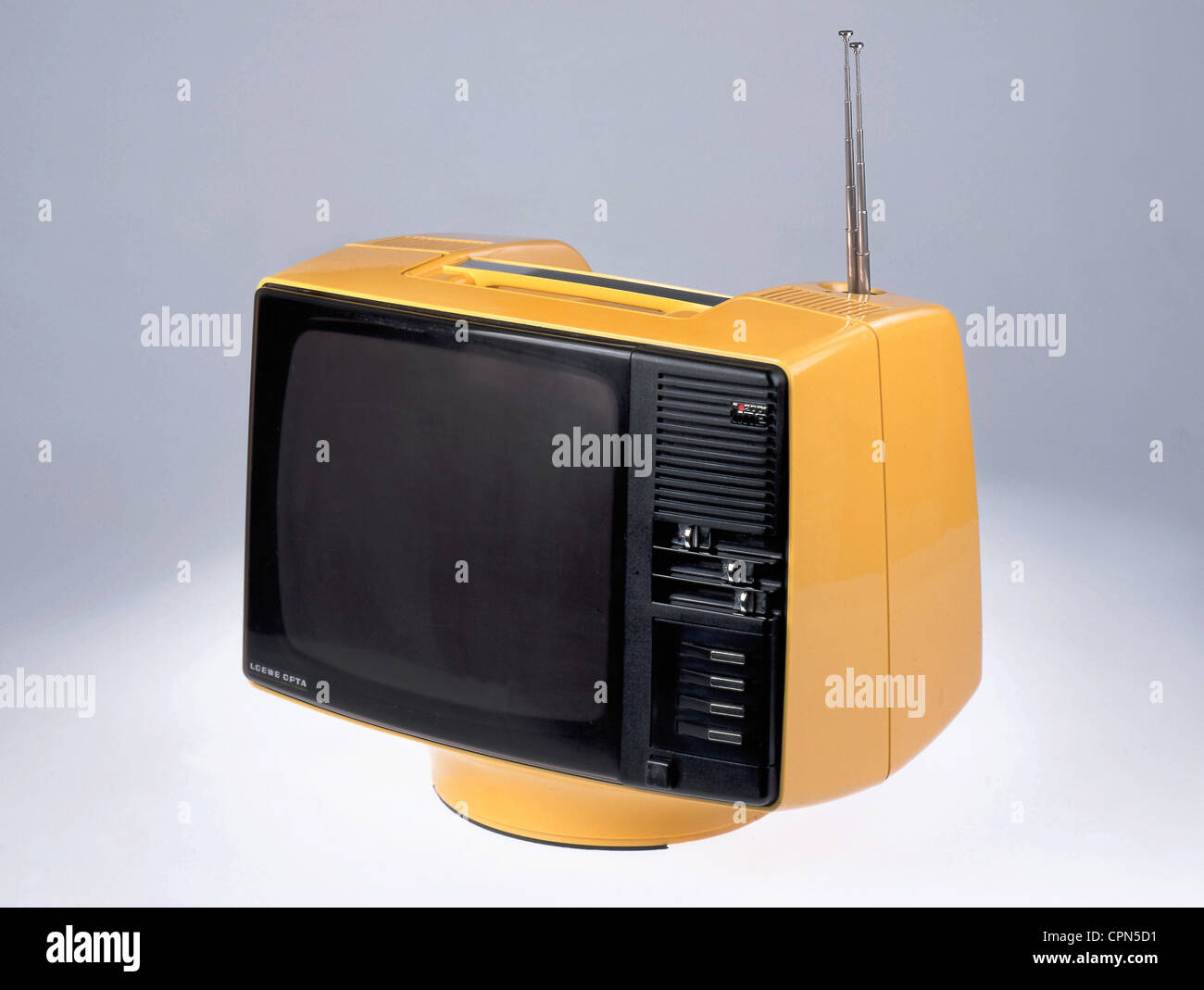 broadcast,television,television set Loewe P 30 line 2001,portable,screen: 31 centimeter,weight: 8 kilogram,also to be used with battery,made by: Loewe Opta,Kronach,Germany,1972,monochrome,monochrome television set,plastics,synthetic material,synthetic,synthetic materials,synthetics,plastic,yellow,transistor television set,telescopic antenna,rod aerial,push button,push buttons,slide control,contrast filter designator,portable,design television set,TV design,Made in Germany,70s,television set,TV,television sets,TV sets,TVs,TV ,Additional-Rights-Clearences-Not Available Stock Photo