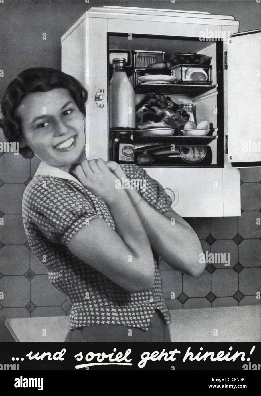 household,kitchen,housewife with refrigerator,advertising for gas refrigerator Elektrolux L 15,original price 1937: RM 295,Germany,1937,wall mounting,household,households,kitchen,kitchens,gas,fluid,gases,cooling food,food,supply,keep fresh,keeping fresh,joy,happiness,happy,purchase,30s,food stock,fill up,filling up,filled up,full,refill,refilled,refills,woman,women,housewife,housewives,homemaker,half length,capacity,volume,volumes,opened,open,space saving,space-saving,space-saving installation,compact,small,mini,,Additional-Rights-Clearences-Not Available Stock Photo