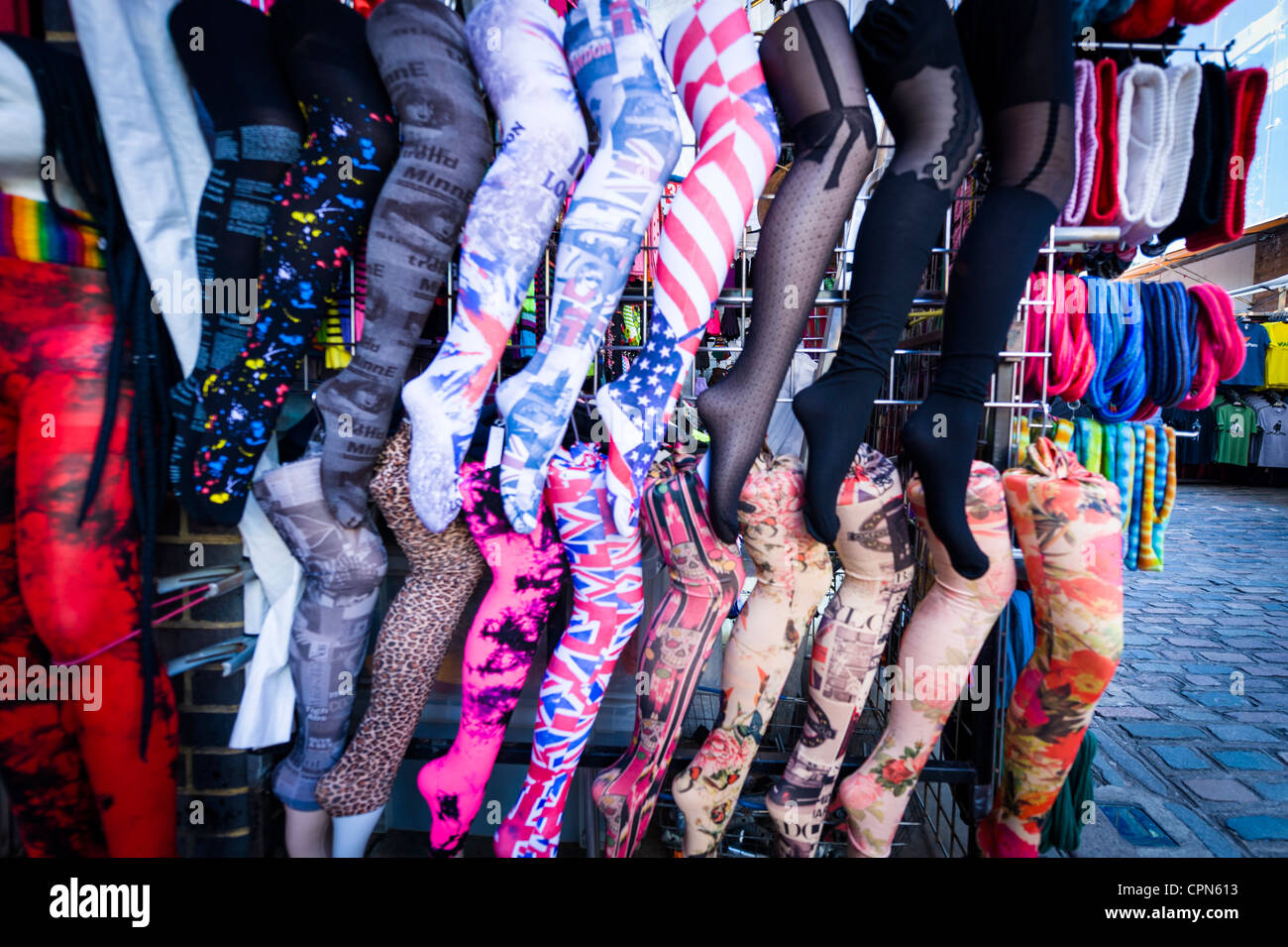London Camden Town Lock Market Stables display of multi colored colorful coloured colourful tights stockings pantyhose hosiery cobble cobbles Stock Photo