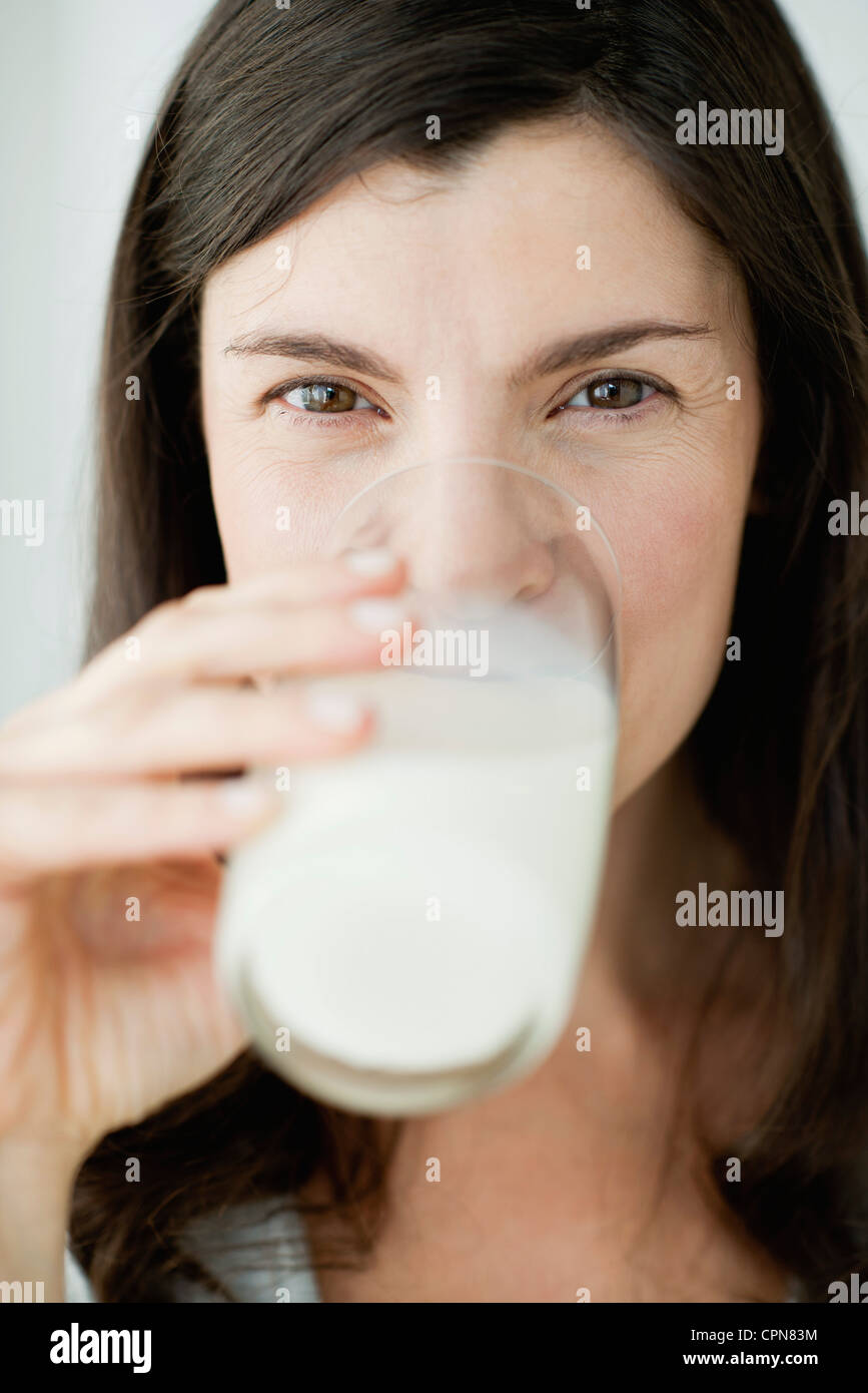 Midadult woman drinking glass of milk Stock Photo Alamy