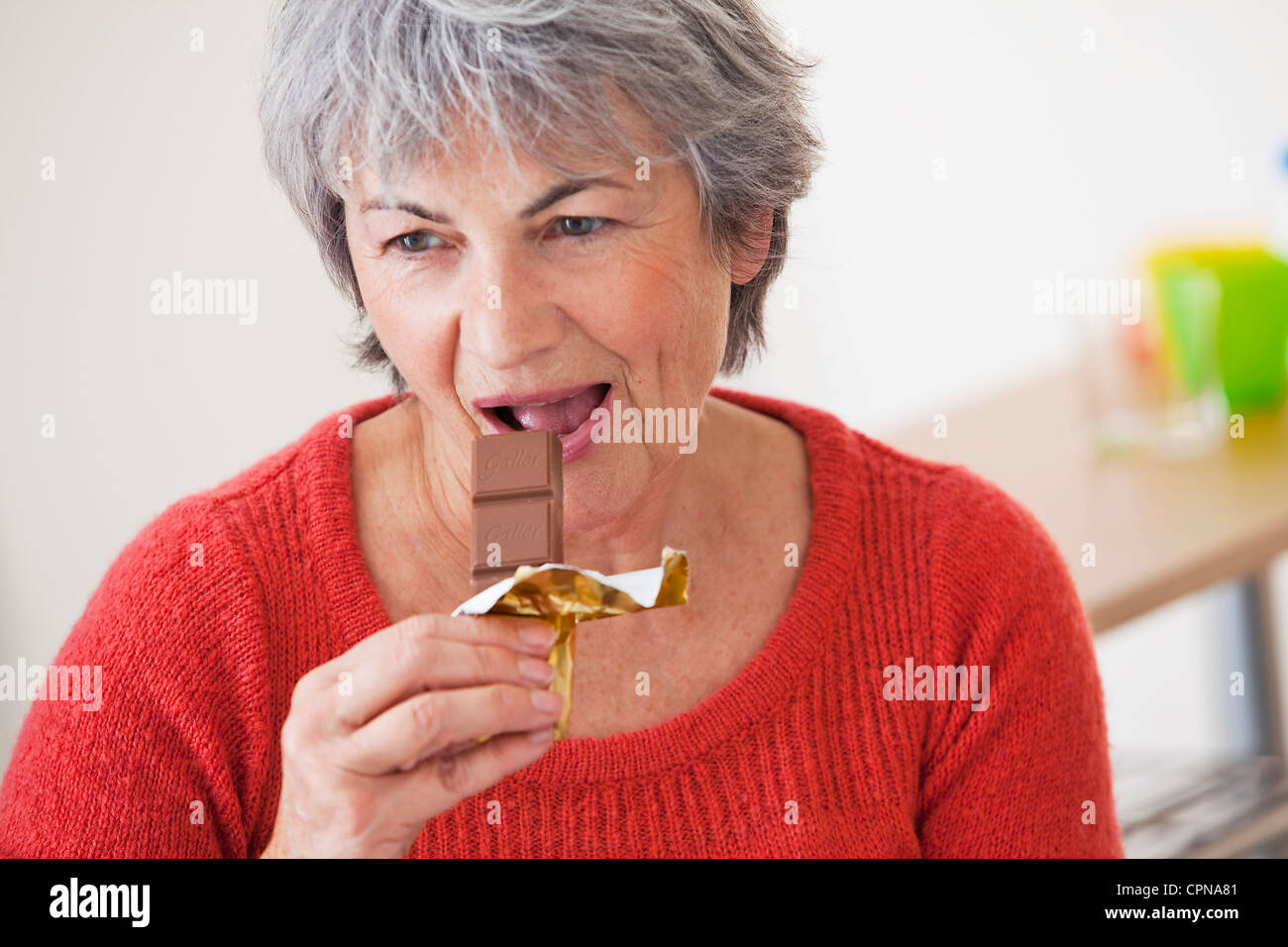 ELDERLY PERSON EATING SWEETS Stock Photo Alamy