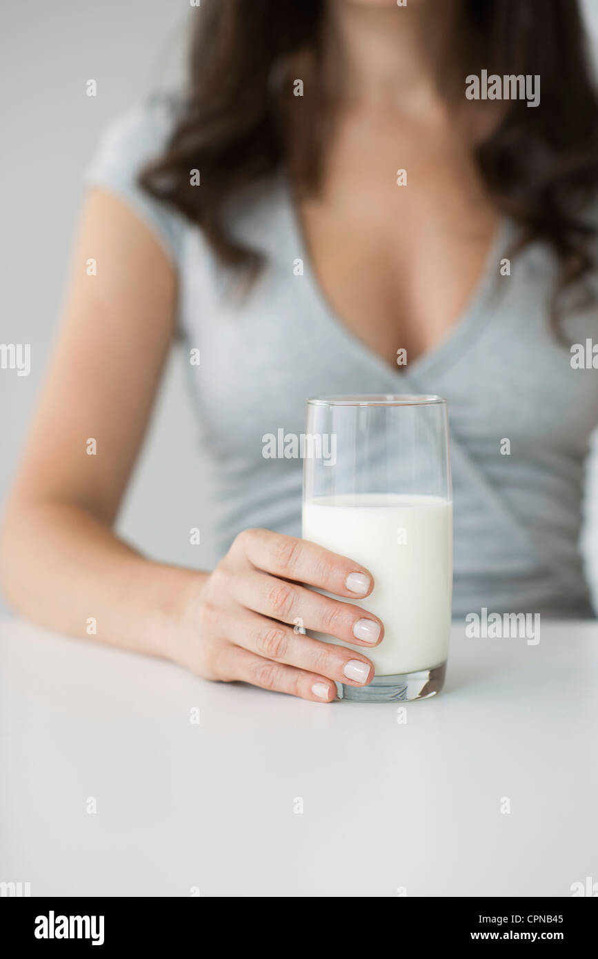 Woman holding glass of milk Stock Photo