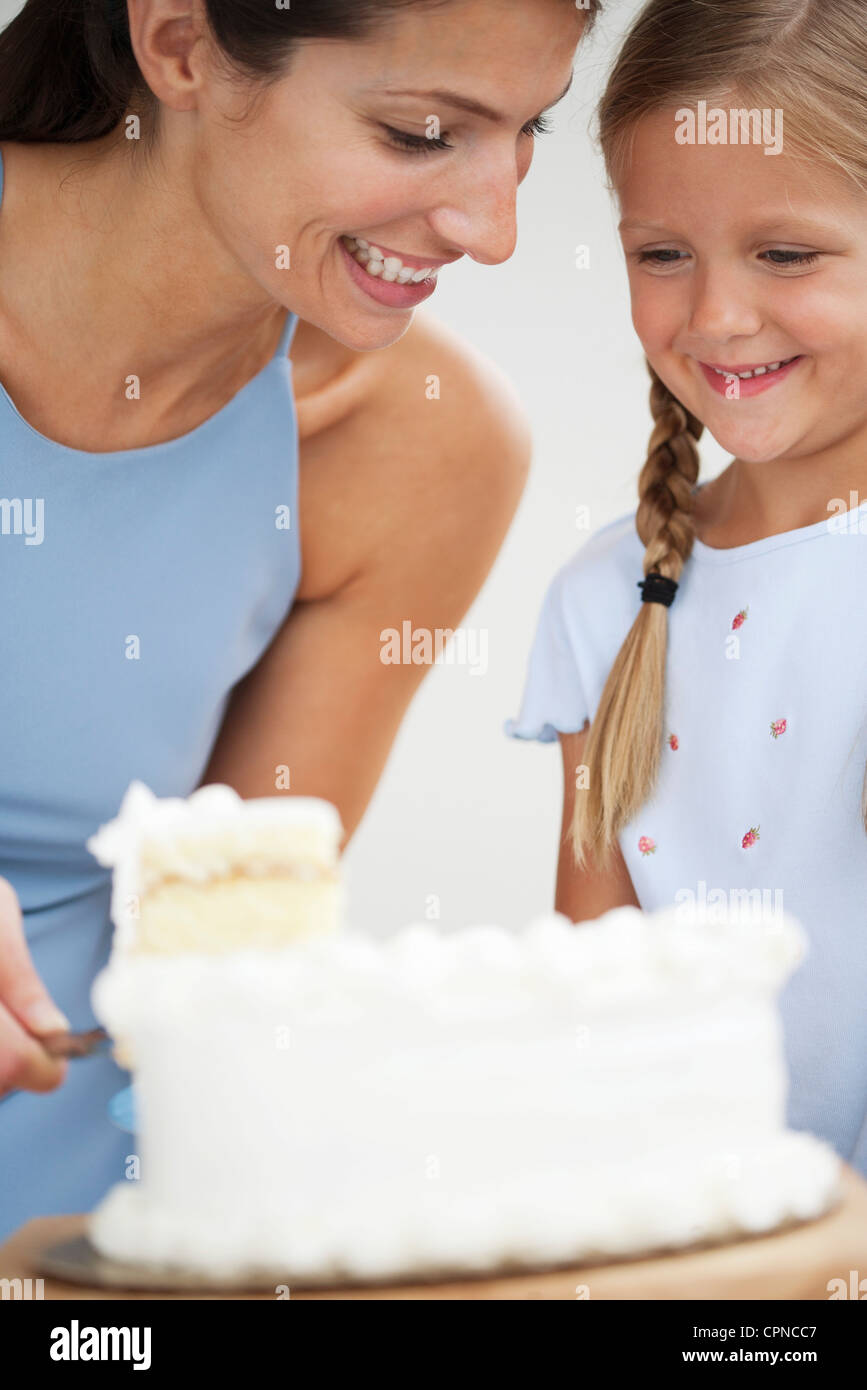 Mother and daughter cutting cake Stock Photo