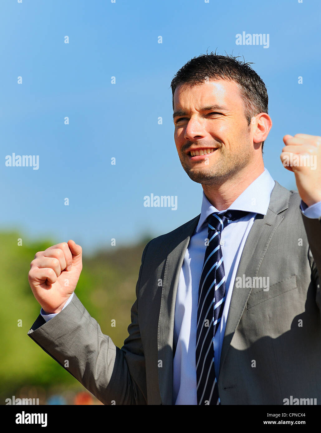 Portrait of a businessman outdoor with winner spirit Stock Photo - Alamy
