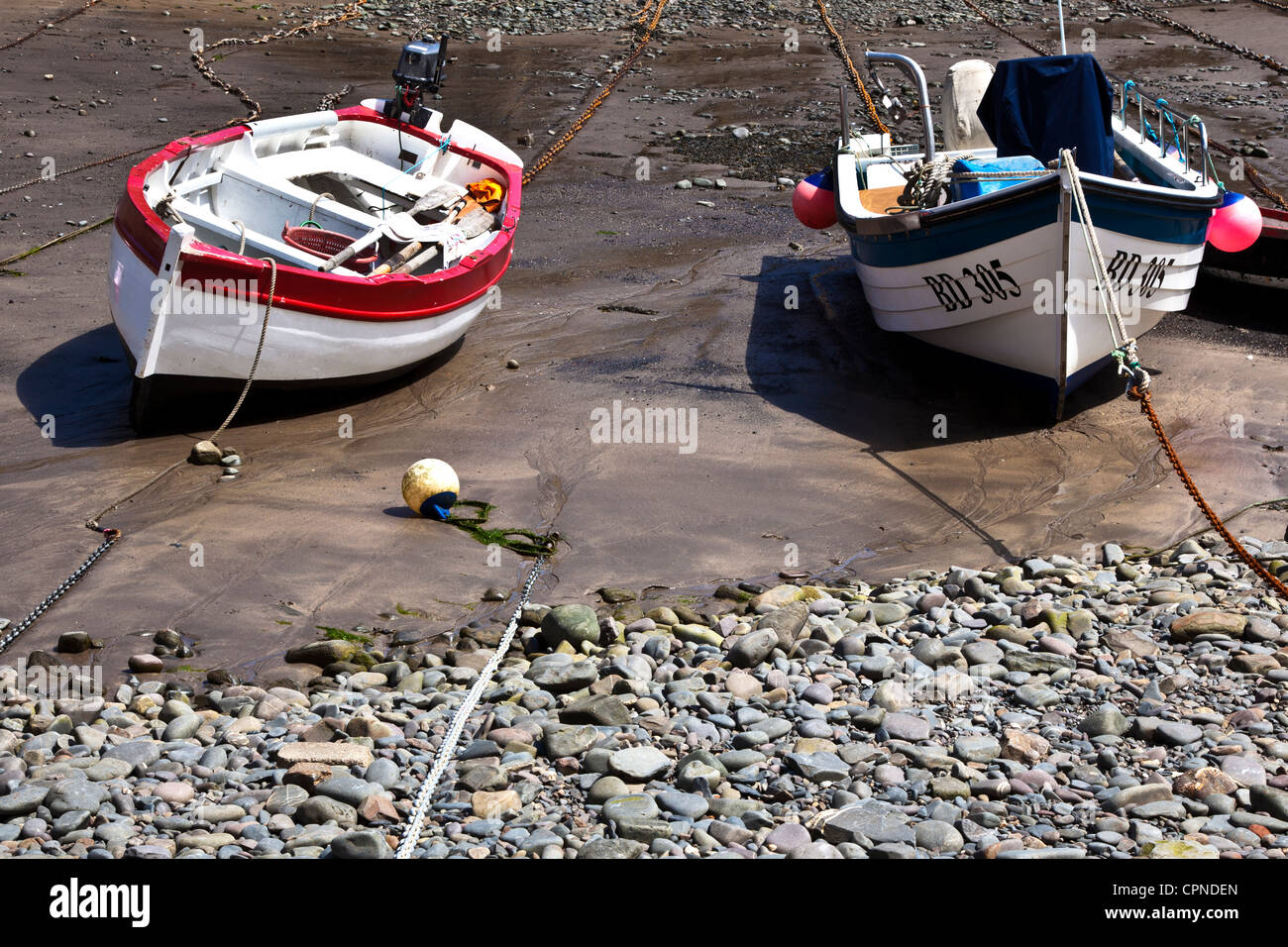 Two Fishing Boats Lying Idle at Low Tide in Harbour at Clovelly in North Devon Stock Photo Alamy