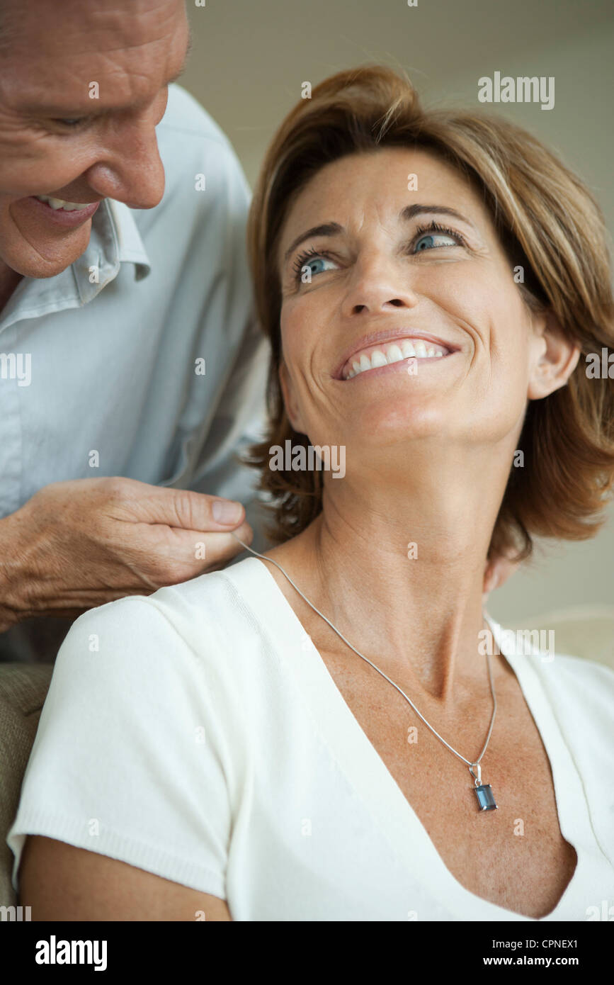 Mature man giving woman necklace Stock Photo - Alamy