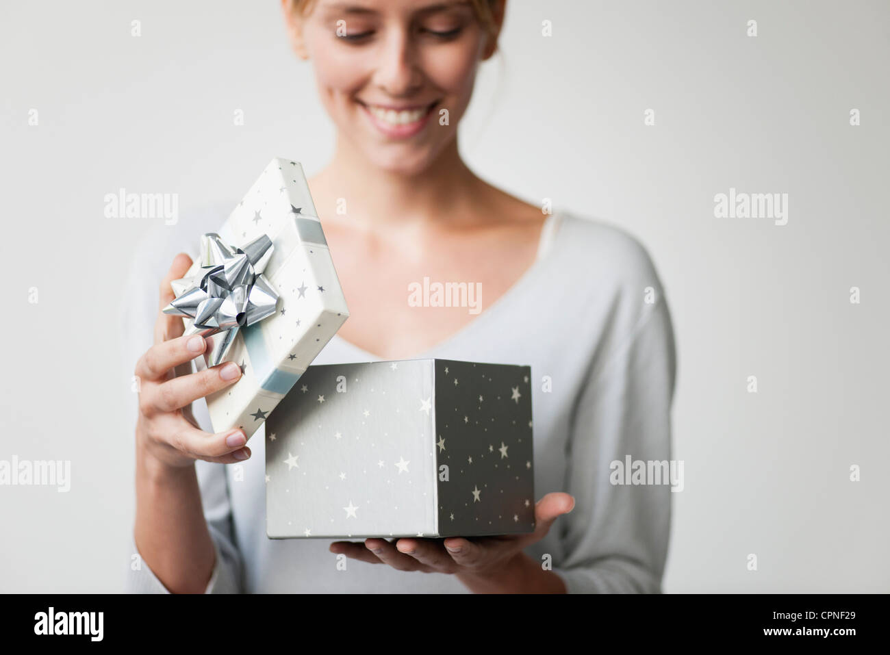 Young woman opening gift box Stock Photo