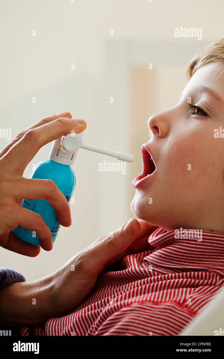CHILD USING SPRAY IN MOUTH Stock Photo Alamy