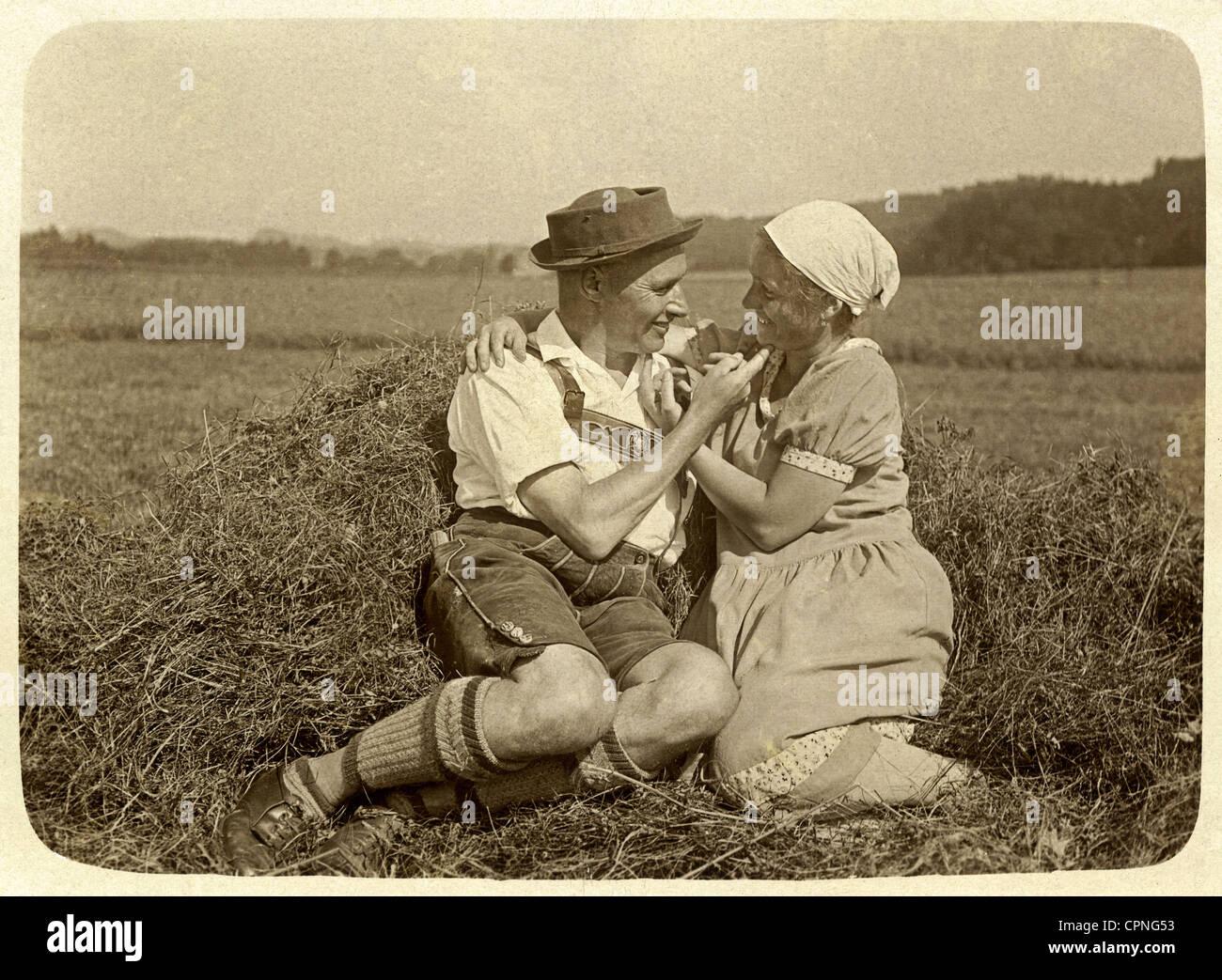 Lovers flirting in bavarian traditional costume hi-res stock ...