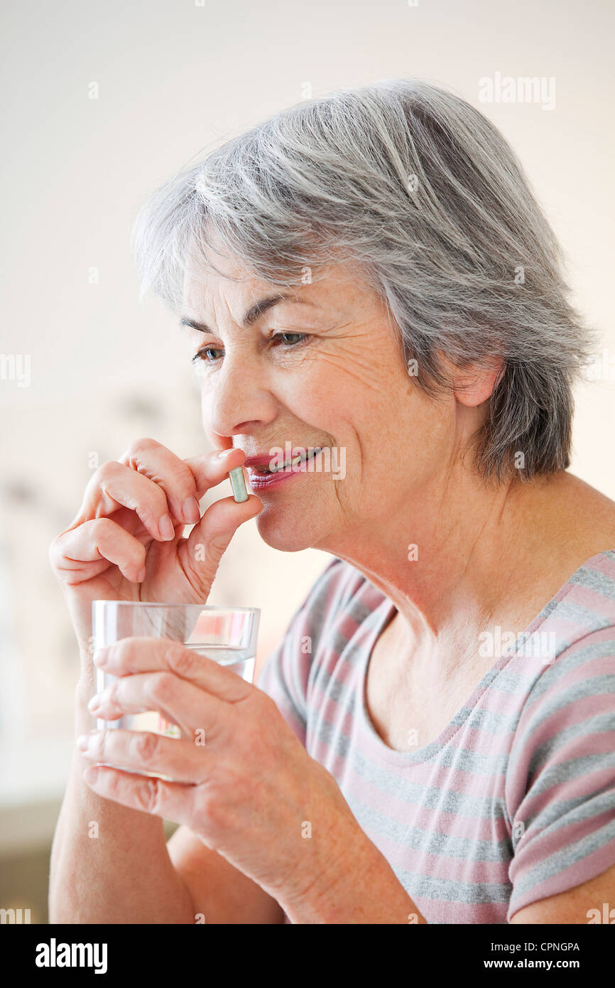 ELDERLY PERSON TAKING MEDICATION Stock Photo Alamy