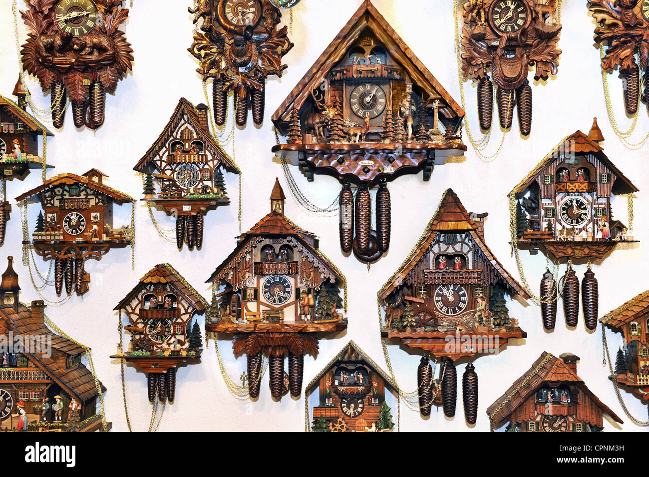 clock, cuckoo clock, Black Forest cuckoo clocks, hanging on the wall, selection in a Munich souvenir shop, Germany, Additional-Rights-Clearance-Info-Not-Available Stock Photo