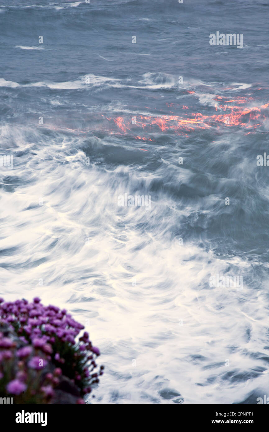 Reflection Of Setting Sun On Choppy Sea Appears Like Flames On The Surface Stock Photo Alamy