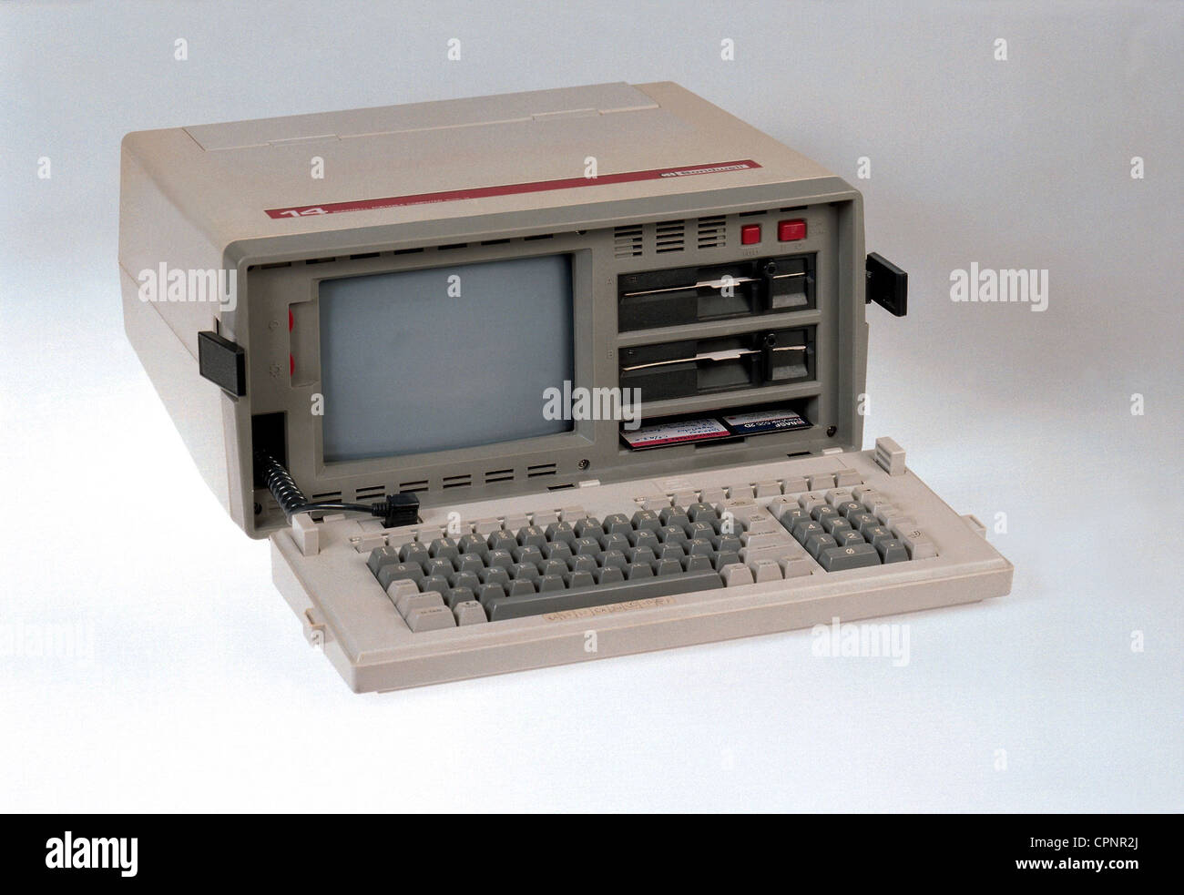 computing / electronics,computer,portable computer Bondwell 14,early laptop,USA,1984,portable computer,weight: 13 kilogram,integrated 9 inch monitor,processor Z80A with 4 megahertz,128 kilobyte random access memory,two built-in 5.25 inch floppy disk drives,operating system CP/M Plus 3.0,keyboard as casing cover,office computer,business computer,office computers,business computers,history of computer,still,object,objects,studio shot,80s,EDP,IT,hardware,personal computer,computer,computers,1980s,20th century,historic,historical,Additional-Rights-Clearences-Not Available Stock Photo