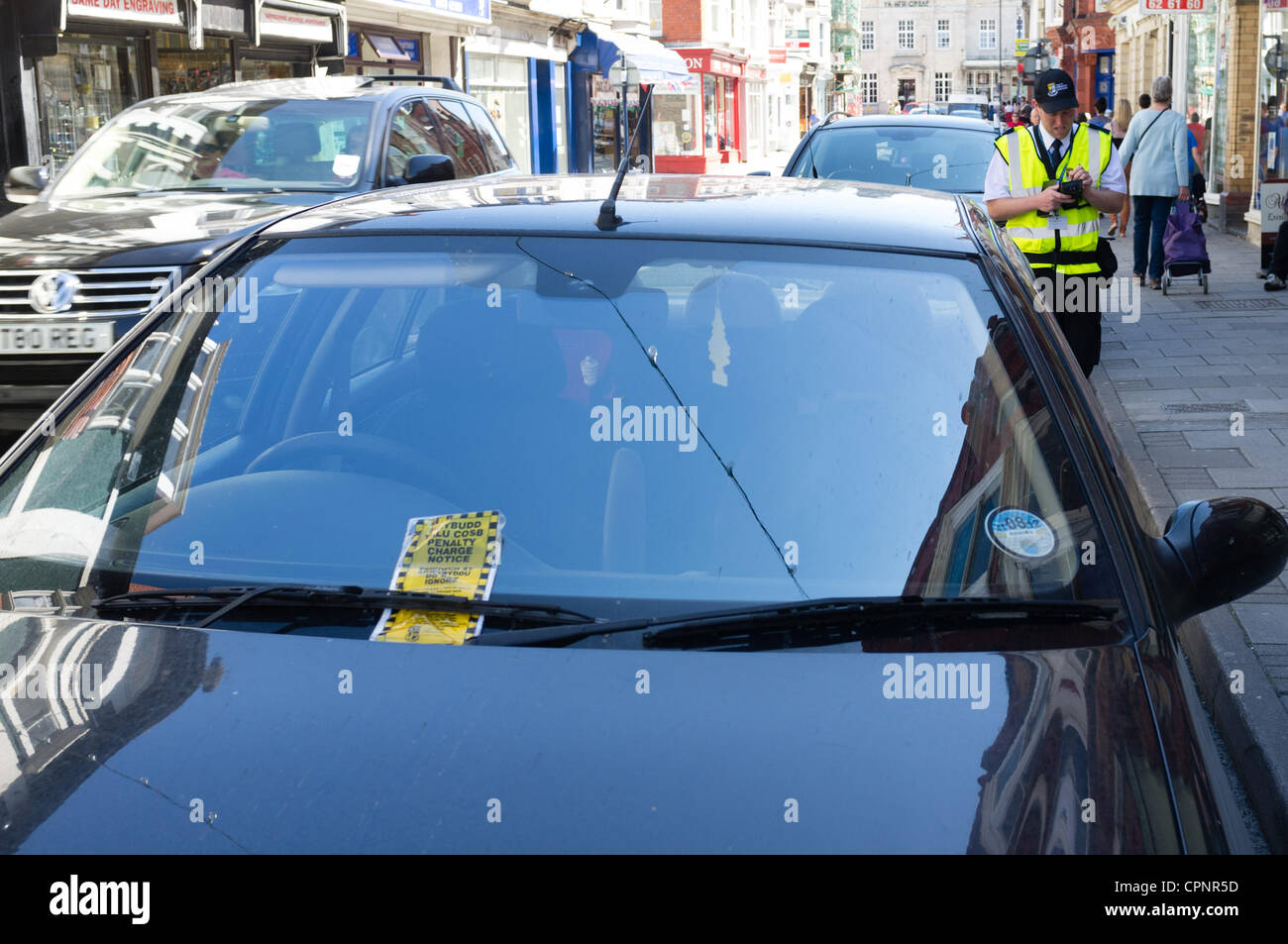 29/05/2012. Aberystwyth, UK. After over 12 months without police traffic wardens, the new local authority-employed Civil Parking Enforcement team return to the streets of the West Wales town. Initially only writing warning notices, they will begin issuing fixed penalty fines from June 4th.  Stock Photo