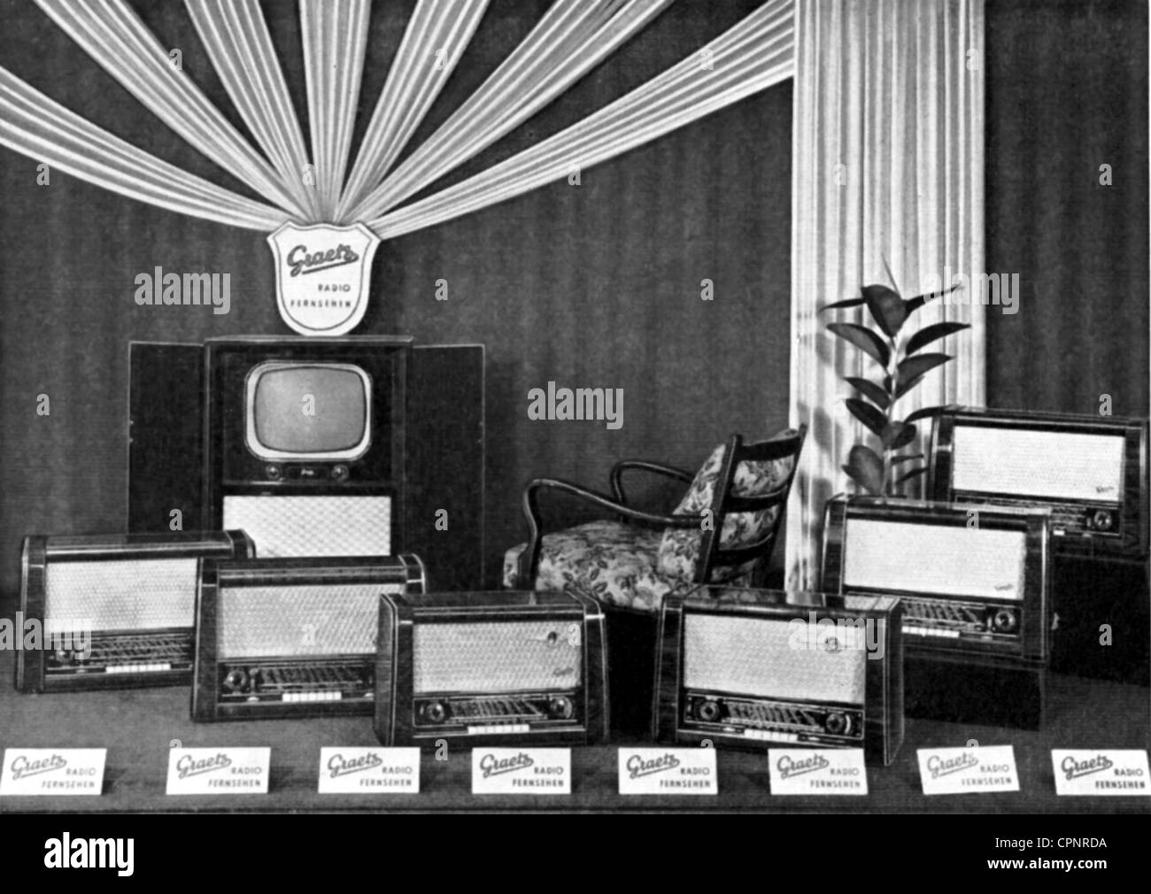 broadcast,television,television set,shop window of a radio- and television shop,with the latest sets of the Graetz Company,also television set F 10,television console with closeable blinds,proposition of a ideal shop window decoration of the Graetz Company for their customers,Germany,1953,window dressing,window dressings,window display,presentation of goods,sale,sales,retail trade,retailing,retail and wholesale,retail,broadcasting services,radio shop,radio shops,broadcast trade,TV history,economic miracle,economic miracles,50s,store ,Additional-Rights-Clearences-Not Available Stock Photo