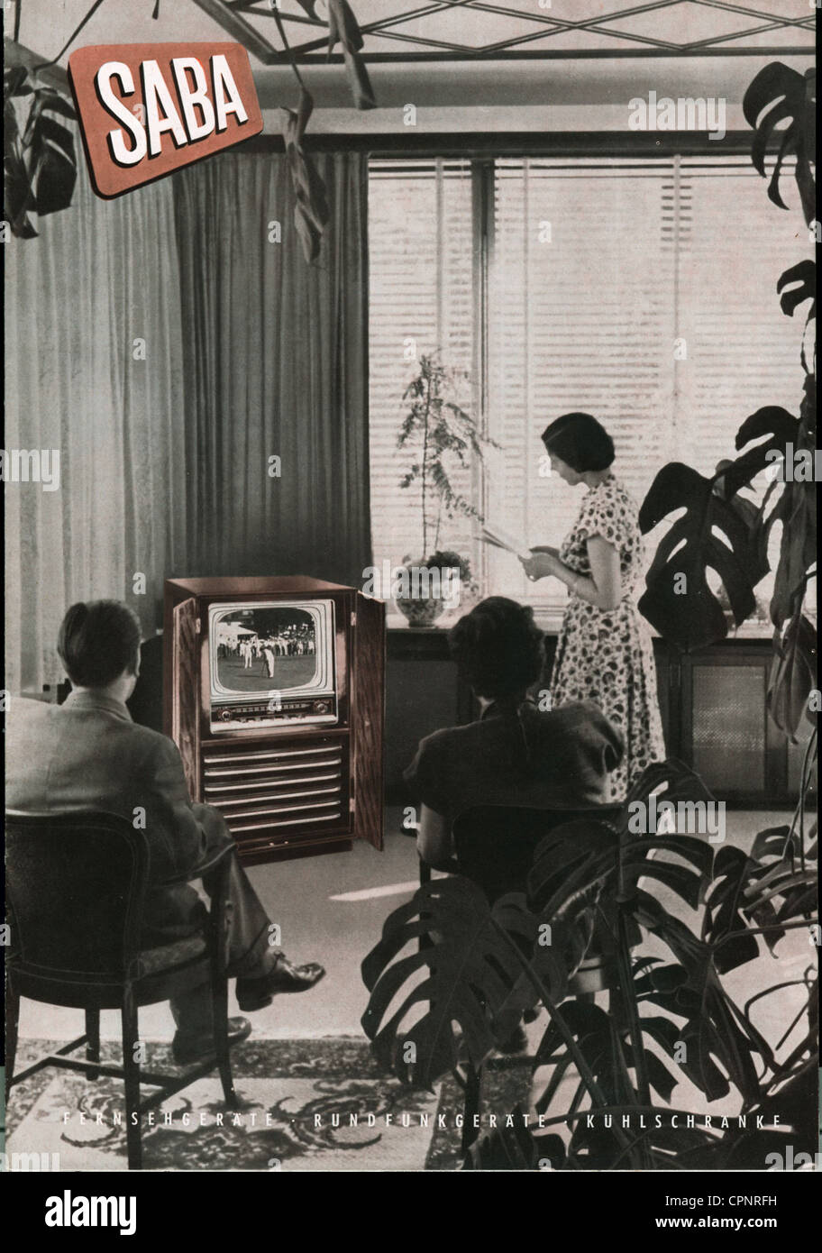 broadcast,television,prospectus,advertising for Saba television set,viewers watching television in the living-room,illustrated: Saba Schauinsland S 44,standalone device with 43 centimeter screen size,standalone device with closeable blinds,original price 1954: DM 1.198,Germany,1954,monochrome,exotic woods,television viewer,television viewers,gum-tree,gum-trees,TV history,economic miracle,economic miracles,50s,prospectus,catalogue,watching,watch,living-room,sitting-room,livingroom,living-rooms,sitting-rooms,livingrooms,television s,Additional-Rights-Clearences-Not Available Stock Photo