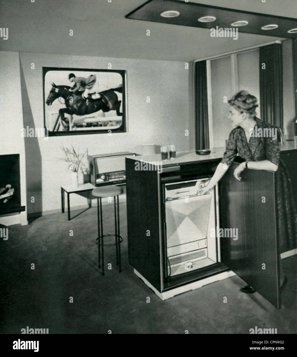 broadcast, television, TV projector Saba Telerama, television picture is projected on special projection screen, viewer is setting the television set, television picture displays a sportscast, Germany, 1960, Additional-Rights-Clearences-Not Available Stock Photo