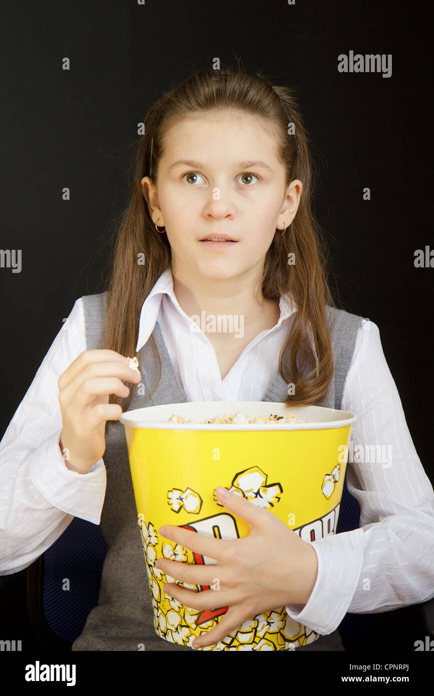 girl with popcorn on a black background Stock Photo Alamy