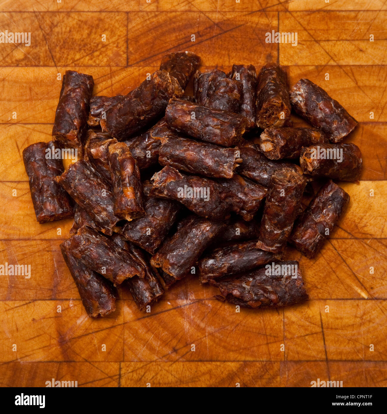 South African spicy Peri peri drywors (dried sausage jerky) on a wooden