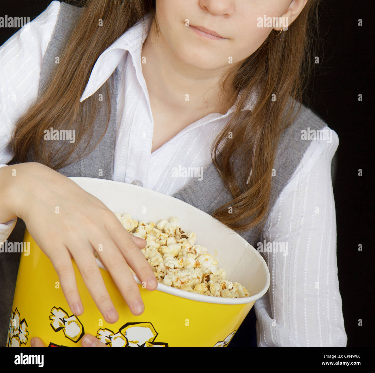 girl with popcorn on a black background Stock Photo Alamy