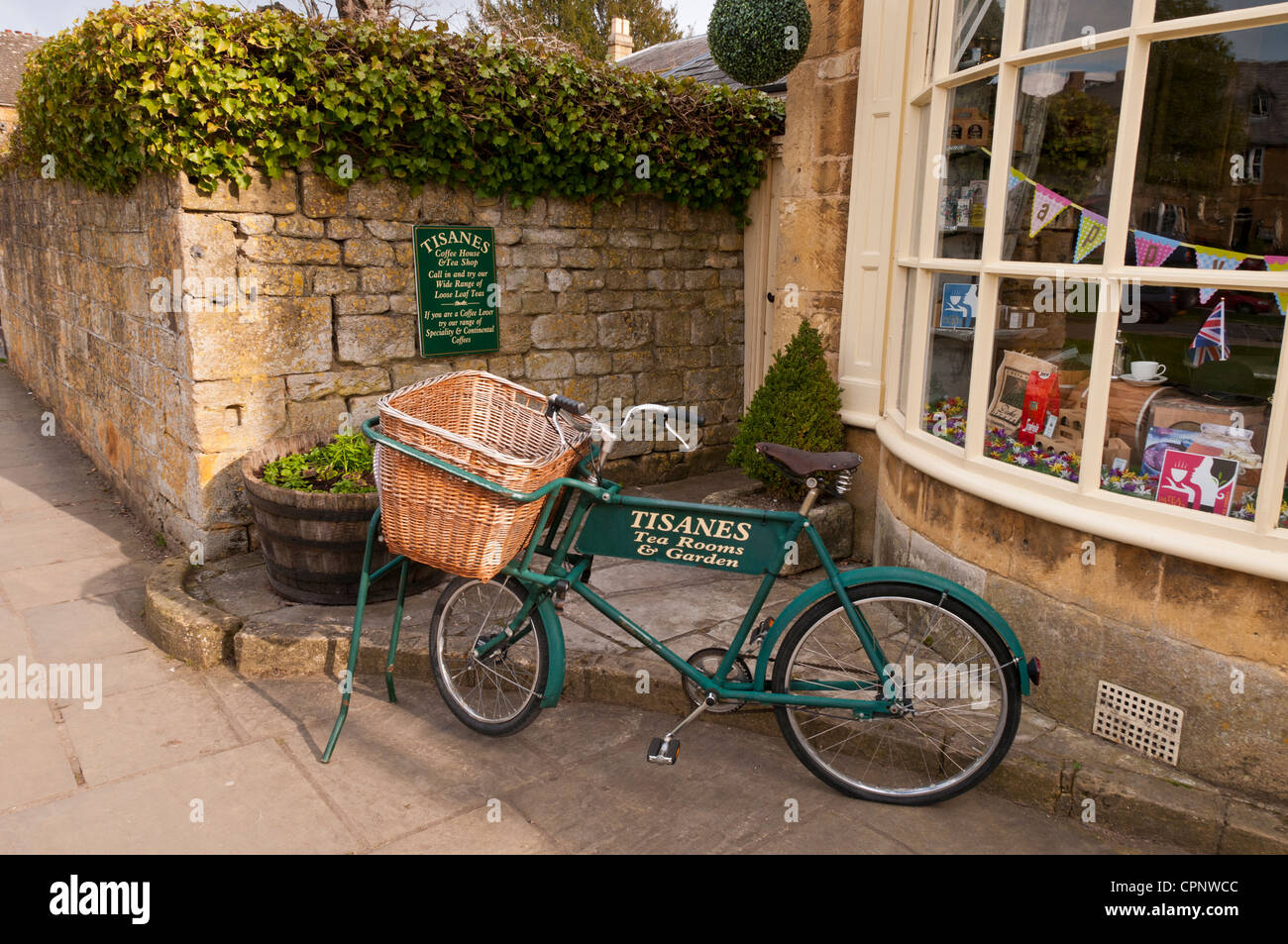 Old bike used as shop sign for Tisanes Tea Rooms, Broadway, Worcestershire, Cotswolds, UK Stock Photo