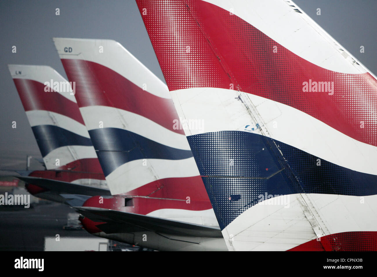 3 British Airways 747 tail thins line up at London Heathrow airport after flights are delayed by fog Stock Photo