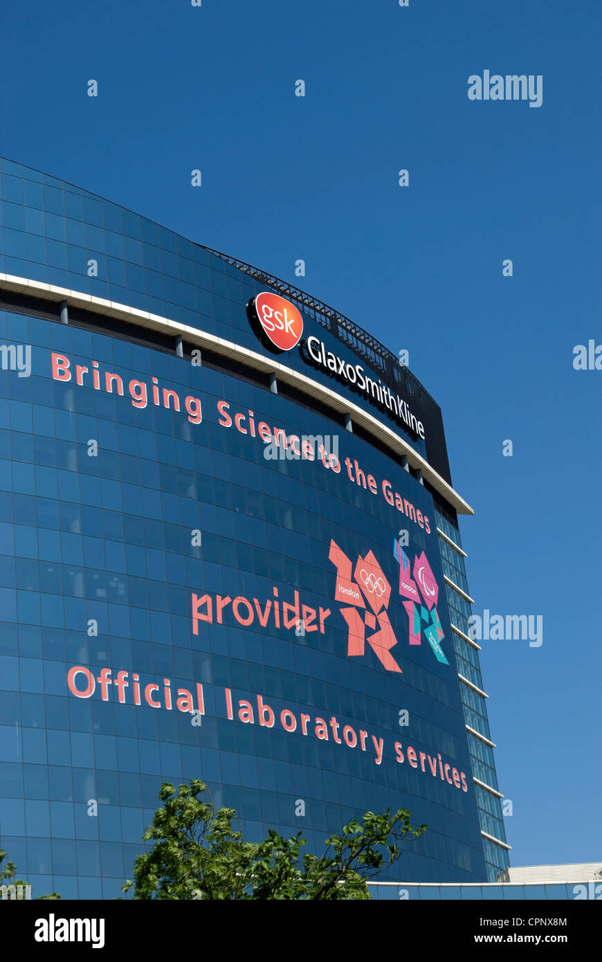 headquarters of gsk, glaxo smith kline, with 2012 olympic games logo noting company's role in providing drug testing for games Stock Photo