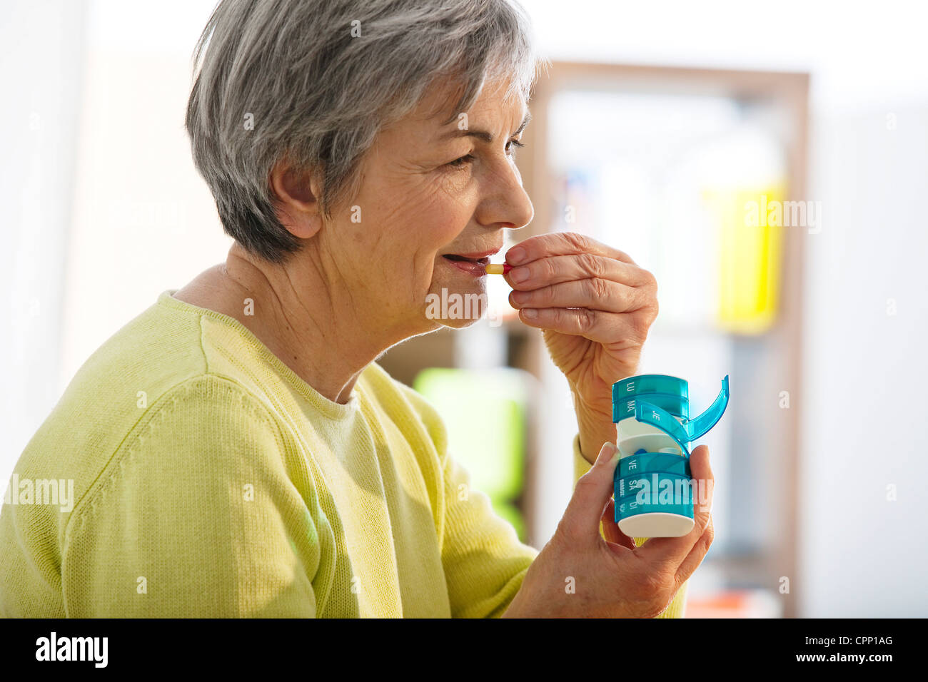 elderly person taking medication