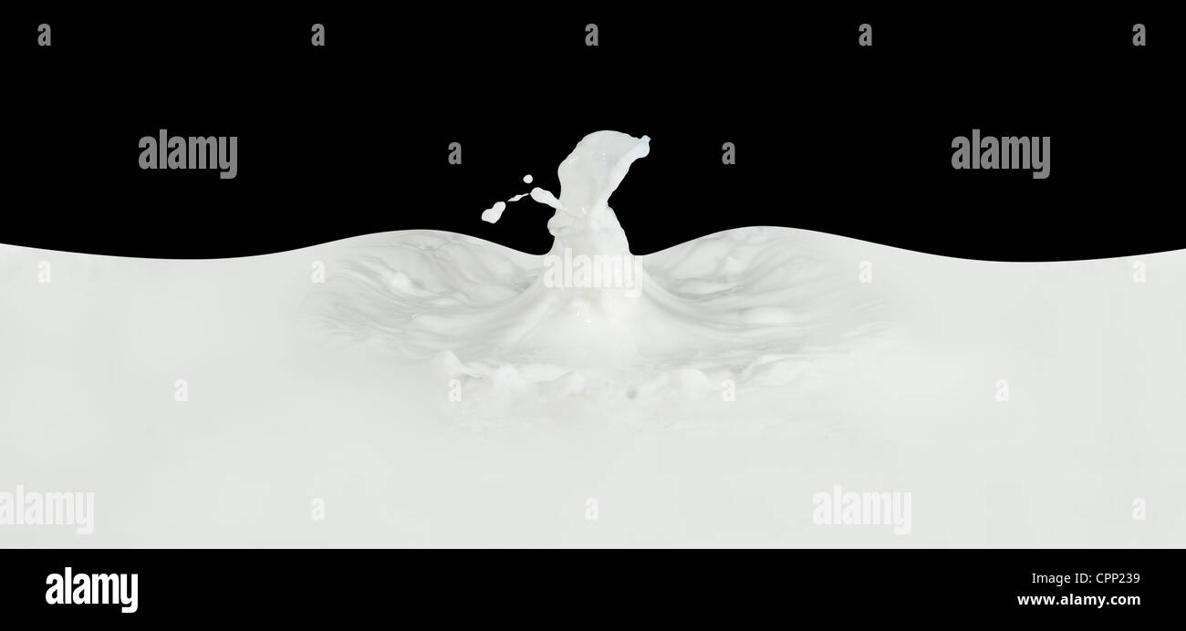 splashing milk isolated on black background Stock Photo - Alamy