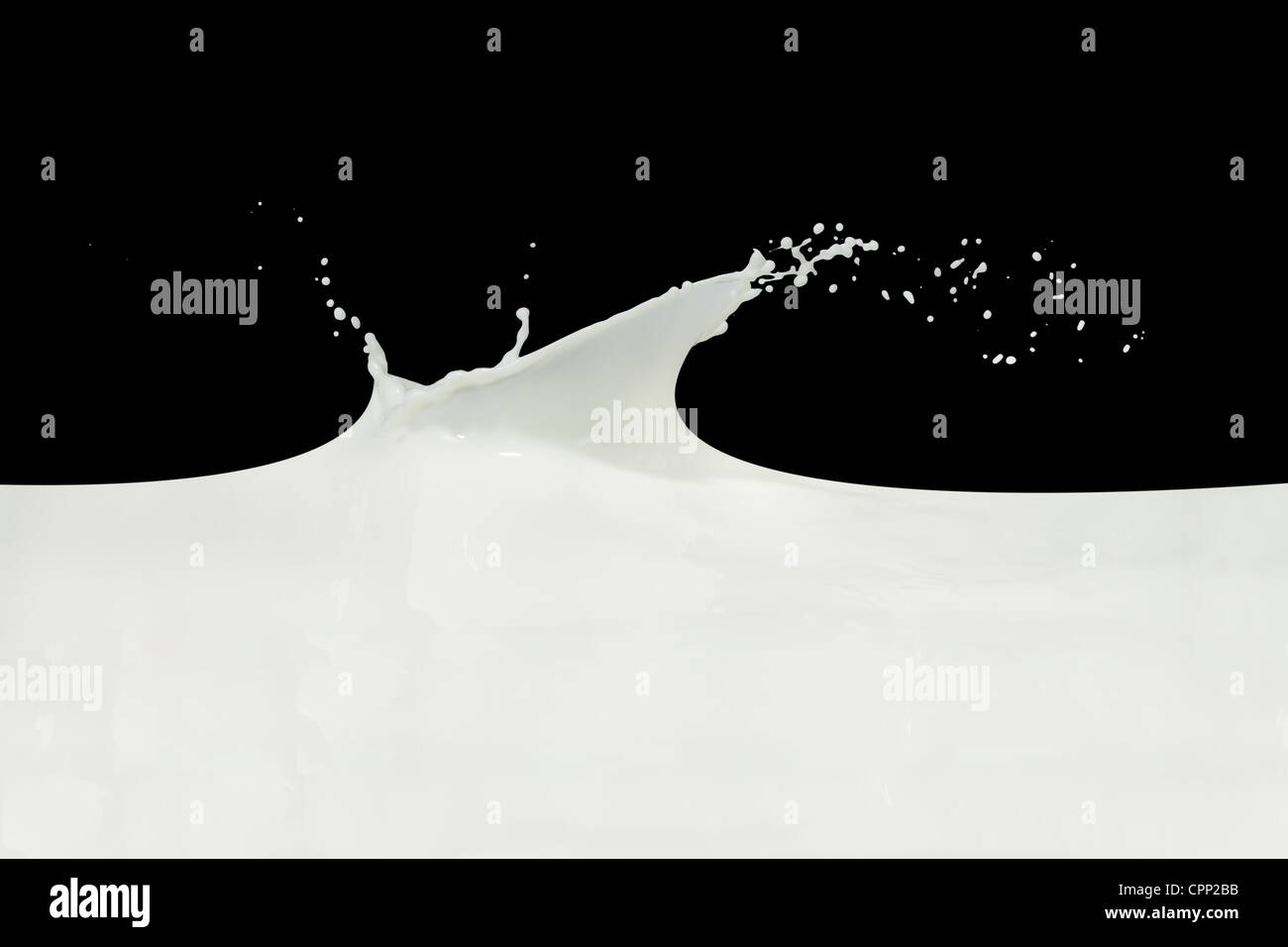 splashing milk isolated on black background Stock Photo - Alamy